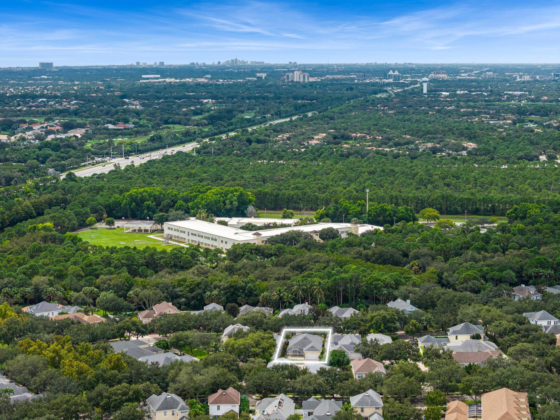 254 Marlberry Circle, Jupiter, FL 33458 Aerial with the residence outlined amid mature oaks and nearby preserve land