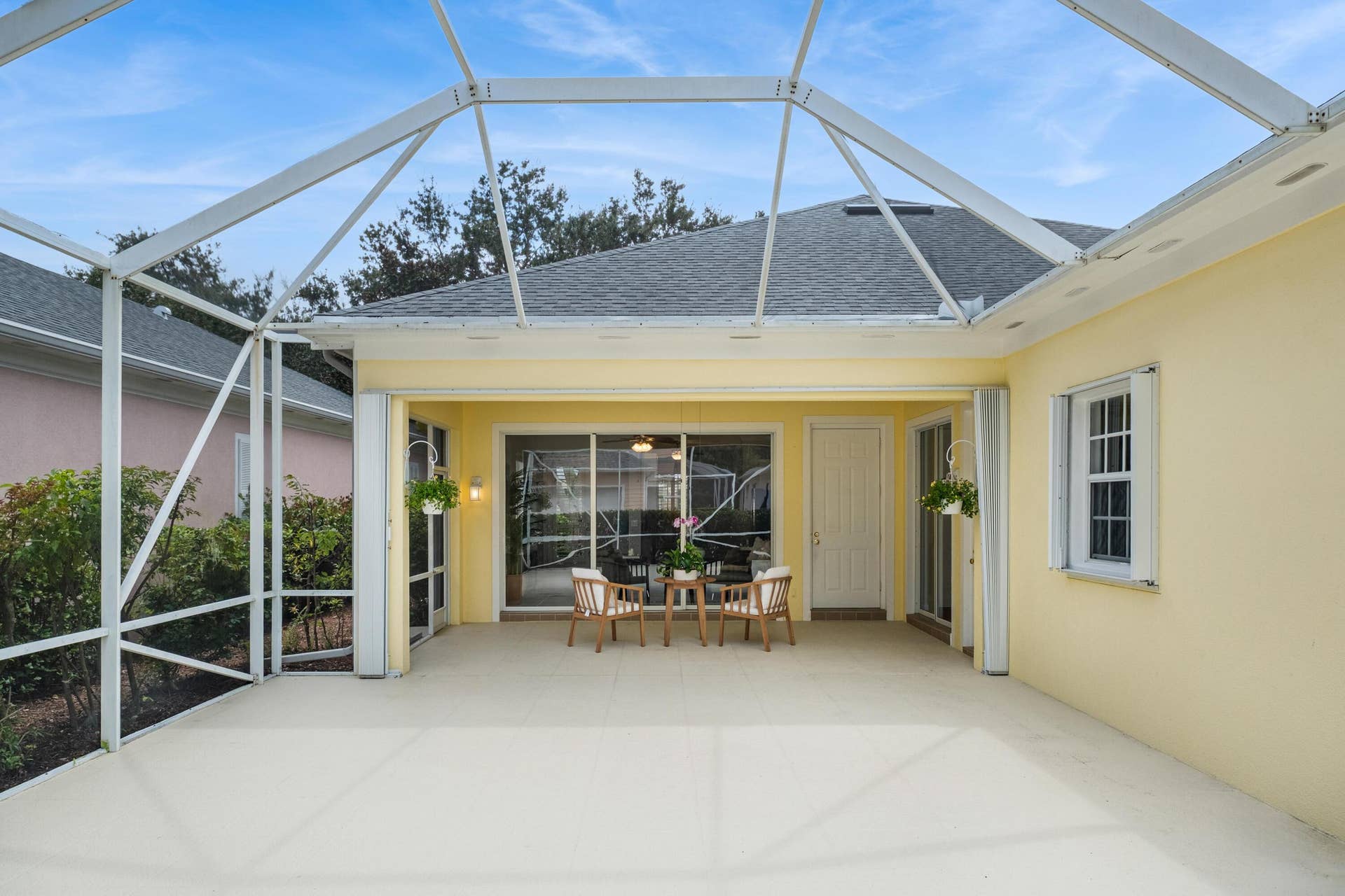 254 Marlberry Circle, Jupiter, FL 33458 Screened patio view of the covered seating area, with multiple sliders into the home