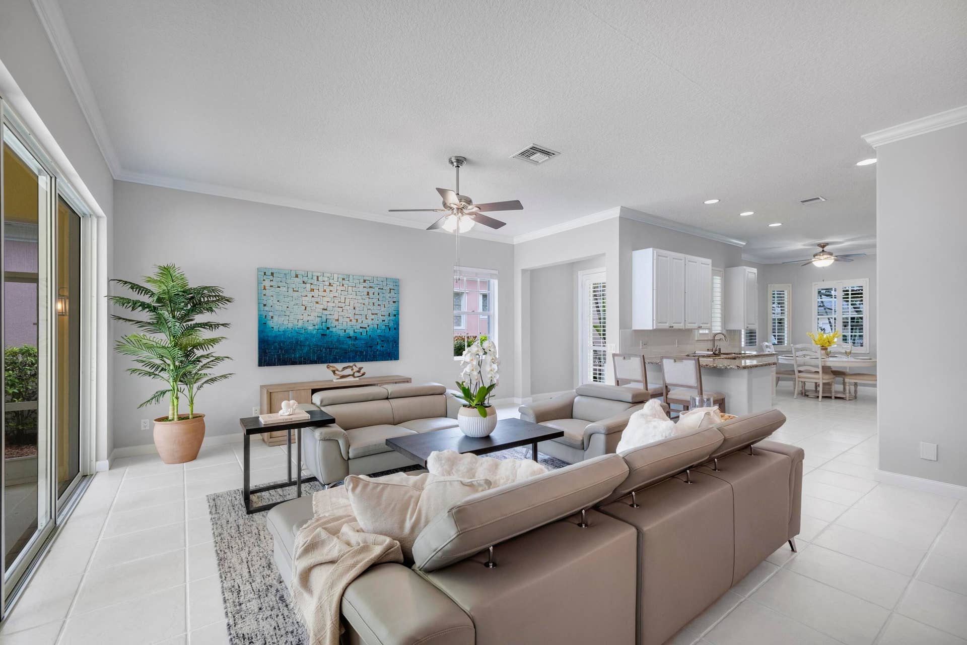 254 Marlberry Circle, Jupiter, FL 33458 Living room with crown molding and recessed lighting, open to the kitchen, formal dining table, and breakfast nook