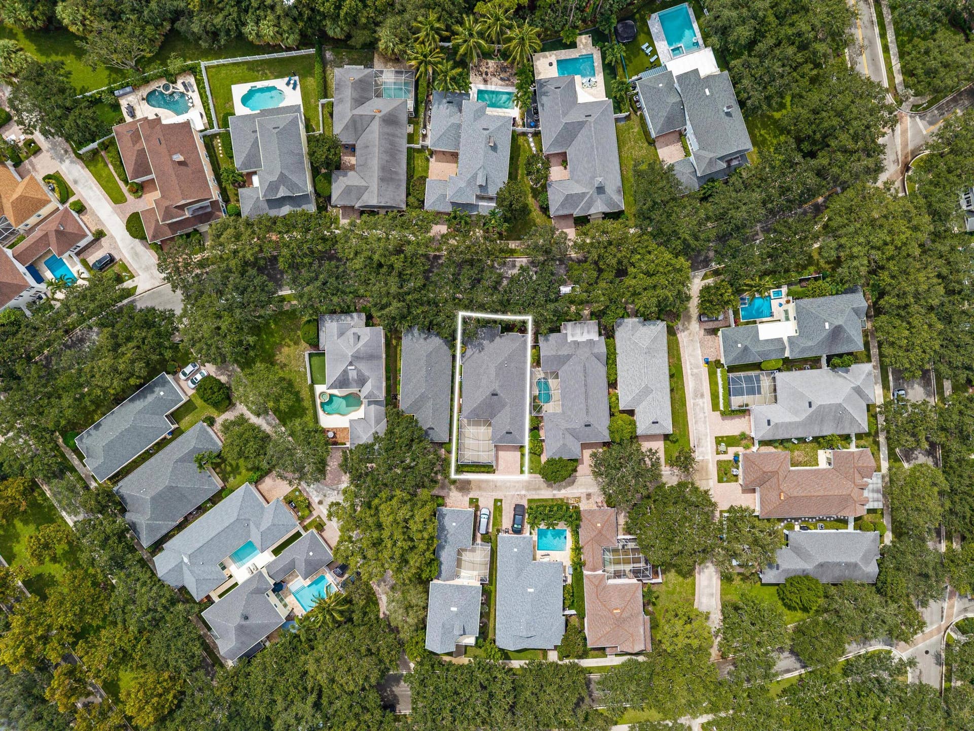 254 Marlberry Circle, Jupiter, FL 33458 Overhead aerial with the homesite outlined within the tree-lined neighborhood