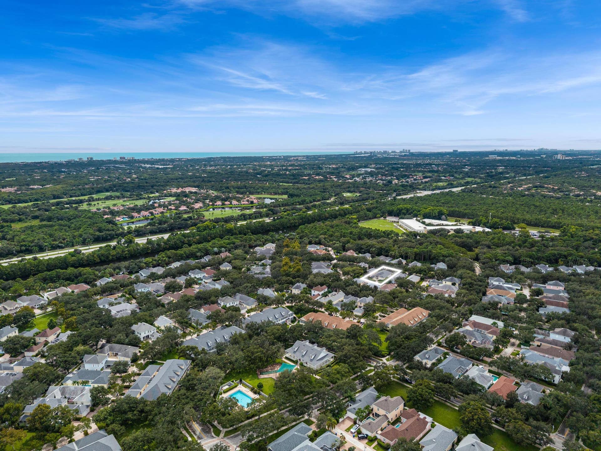 254 Marlberry Circle, Jupiter, FL 33458 Aerial with the residence outlined and the Atlantic Ocean on the horizon
