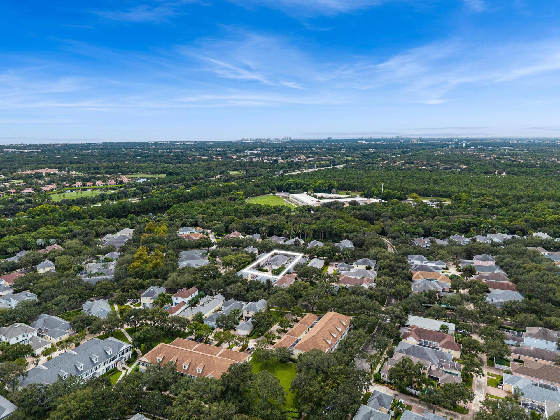 254 Marlberry Circle, Jupiter, FL 33458 Aerial with the residence outlined within the mature, tree-lined neighborhood