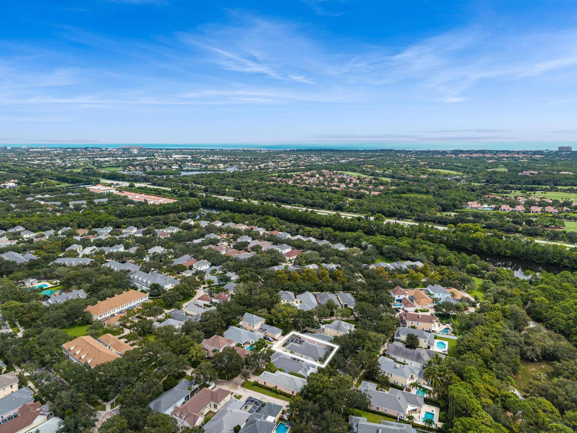 254 Marlberry Circle, Jupiter, FL 33458 Aerial with the residence outlined, with the neighborhood and Atlantic beyond