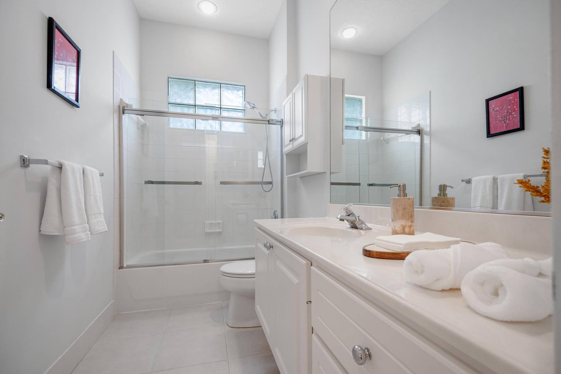 254 Marlberry Circle, Jupiter, FL 33458 Bathroom with a new glass shower enclosure over the tub and a glass block window