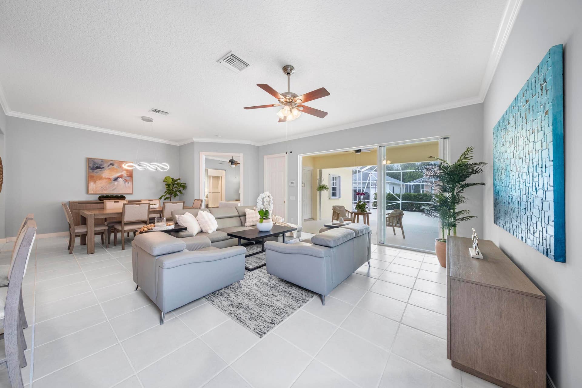 254 Marlberry Circle, Jupiter, FL 33458 Spacious living room with the dining room behind and sliding glass doors to the covered and screened patio