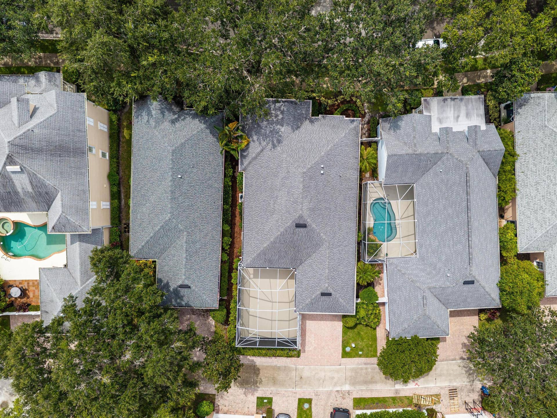 254 Marlberry Circle, Jupiter, FL 33458 Close overhead aerial of the roofline, screened patio and landscaped side yard