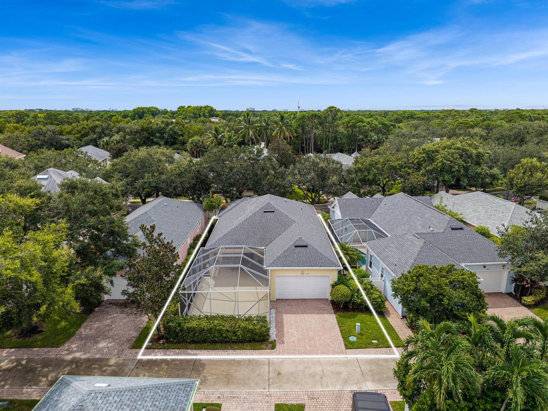 254 Marlberry Circle, Jupiter, FL 33458 Low aerial with lot lines, showing the homesite, screened patio and garage