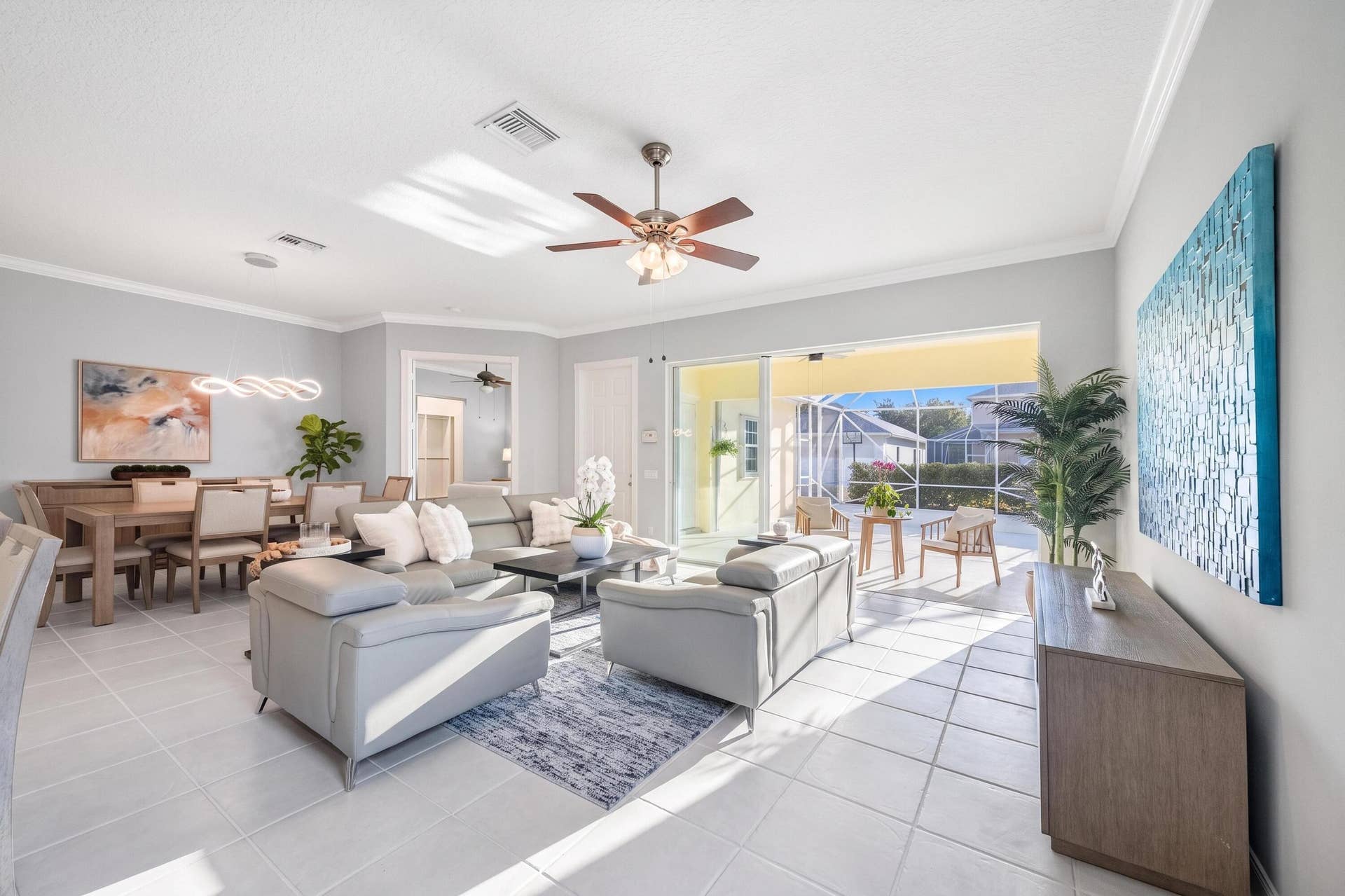 254 Marlberry Circle, Jupiter, FL 33458 Living room with ceiling fan and sliders to the screened patio, and dining room