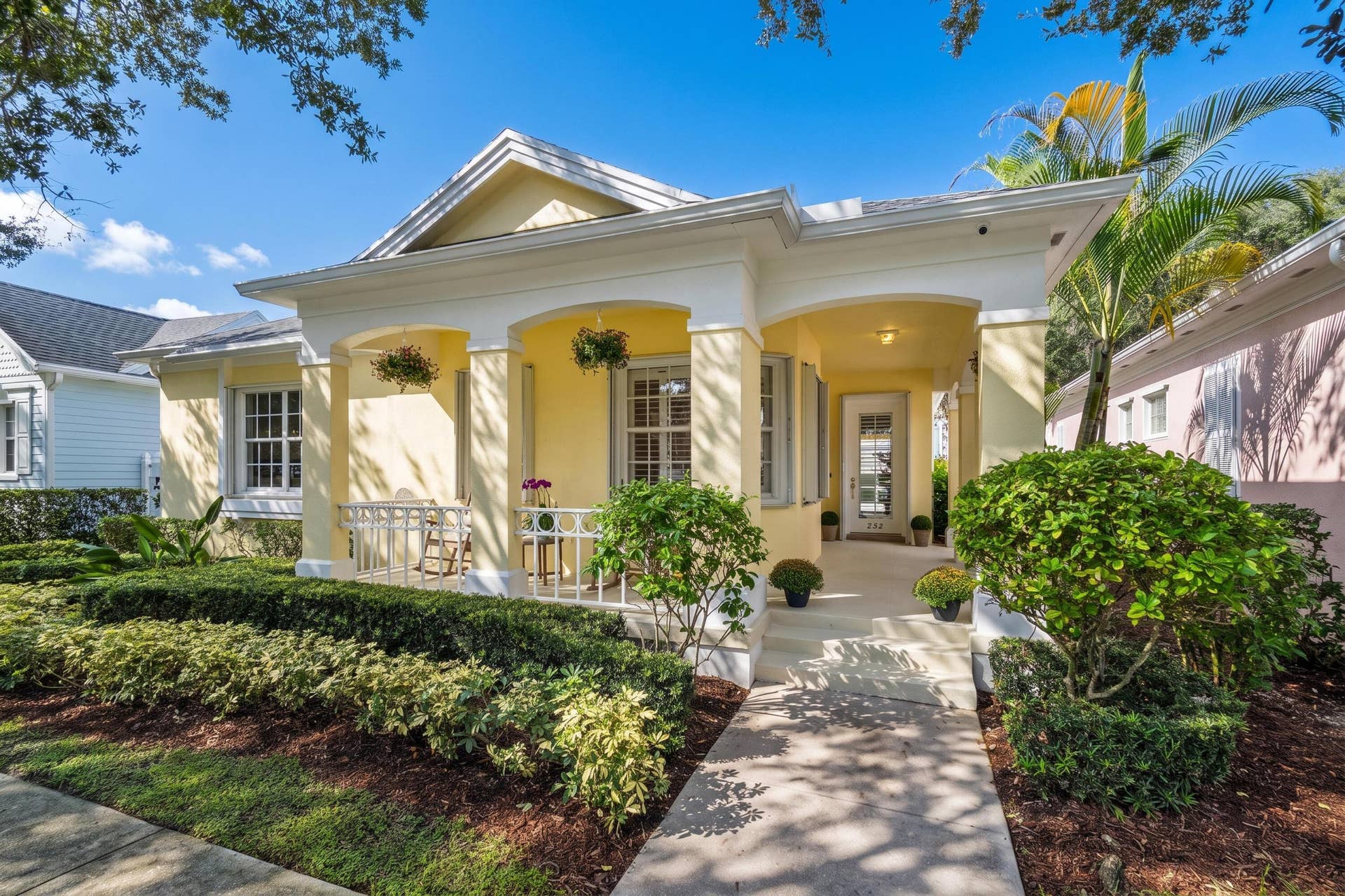 254 Marlberry Circle, Jupiter, FL 33458 Front elevation with arched colonnade, welcoming front steps and manicured landscaping