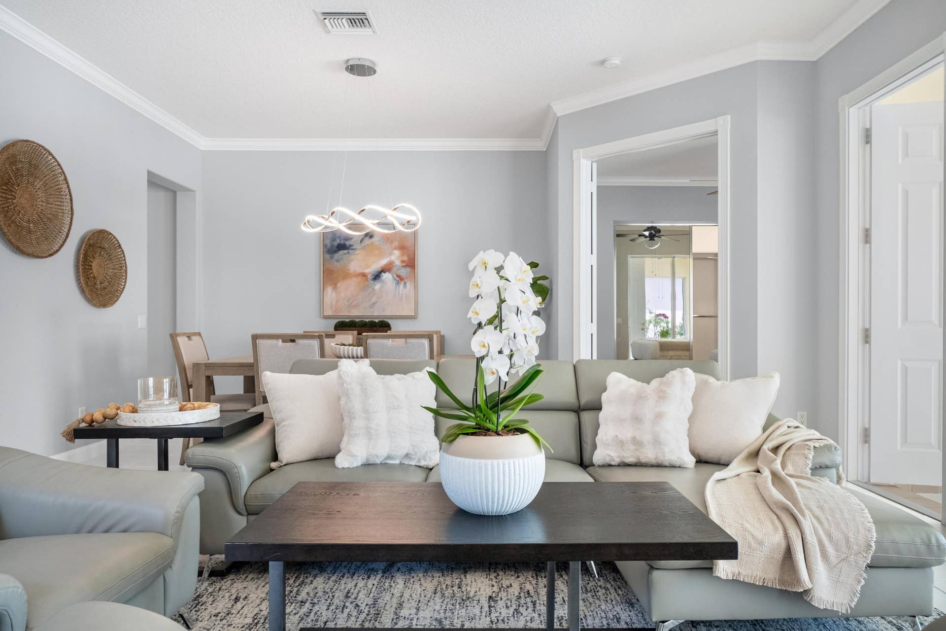 254 Marlberry Circle, Jupiter, FL 33458 Living room and dining room with double doors opening to the primary suite