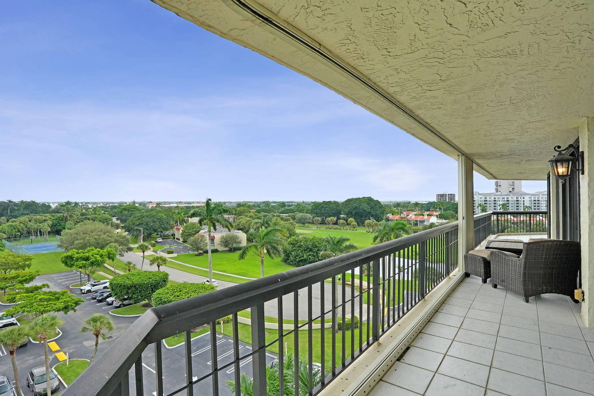 Wraparound balcony overlooking landscaped grounds and golf course
