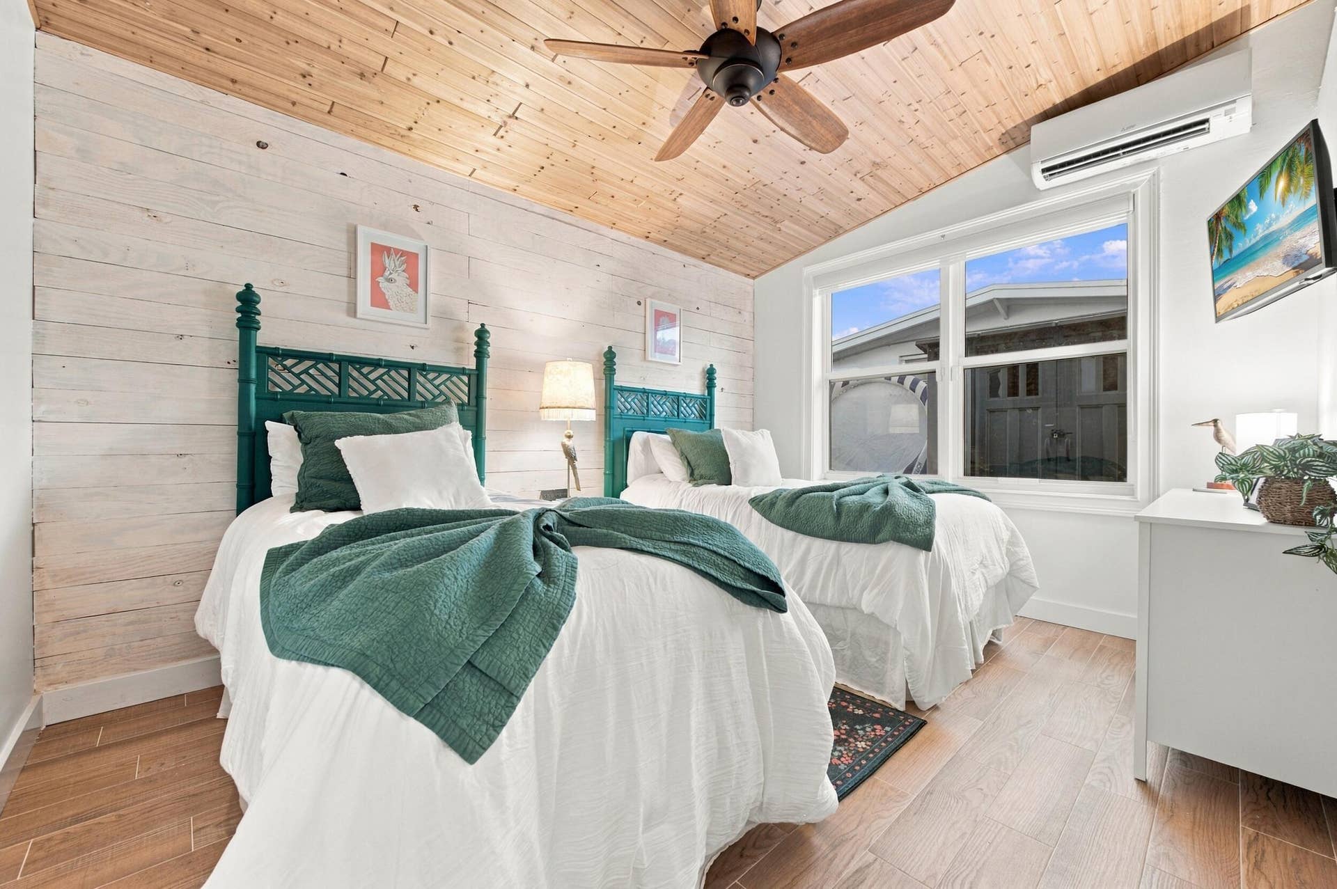 2496 BIMINI Lane, Fort Lauderdale, FL 33312 Vaulted wood-plank ceiling, wood-finish flooring, white shiplap-style wall, dual windows, and an installed air conditioning unit