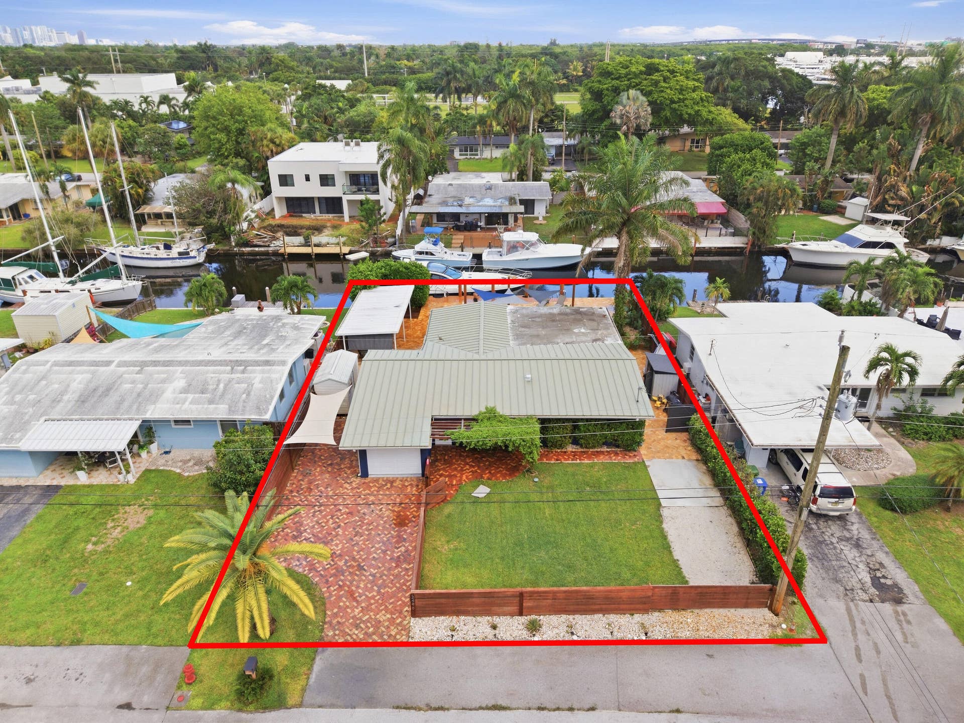 2496 BIMINI Lane, Fort Lauderdale, FL 33312 Aerial perspective highlighting the property's waterfront location, private boat dock, and surrounding canal