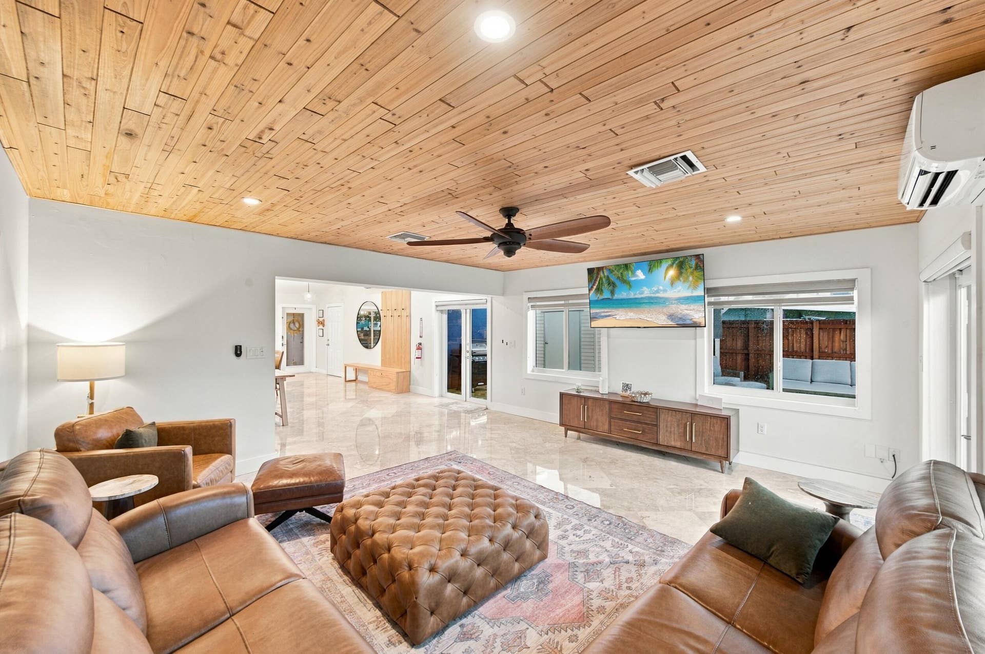 2496 BIMINI Lane, Fort Lauderdale, FL 33312 Wood-paneled ceiling, recessed lighting, ceiling fan, polished tile flooring, and multiple windows