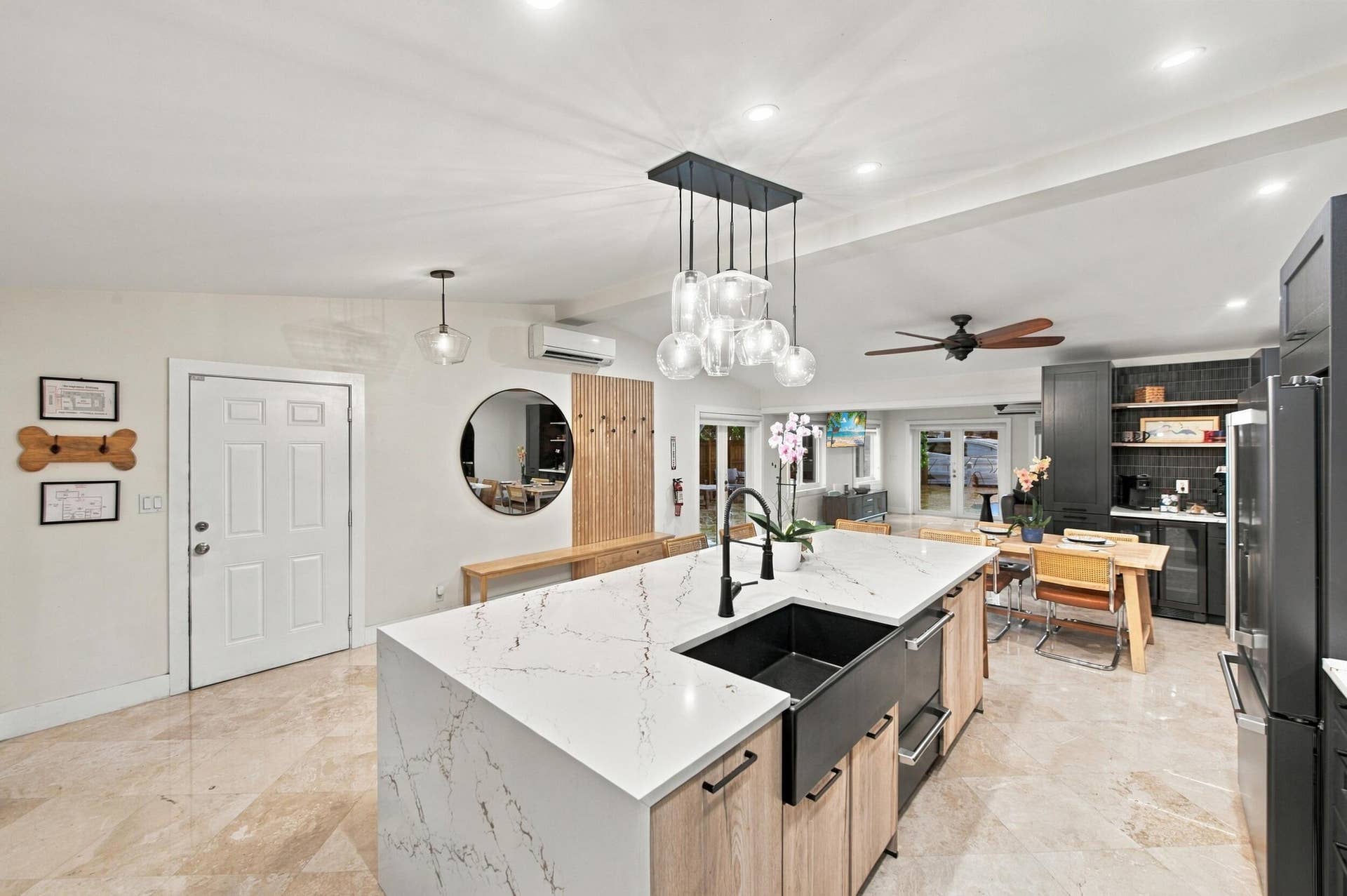 2496 BIMINI Lane, Fort Lauderdale, FL 33312 Waterfall countertop island featuring an integrated farmhouse sink and pendant lighting