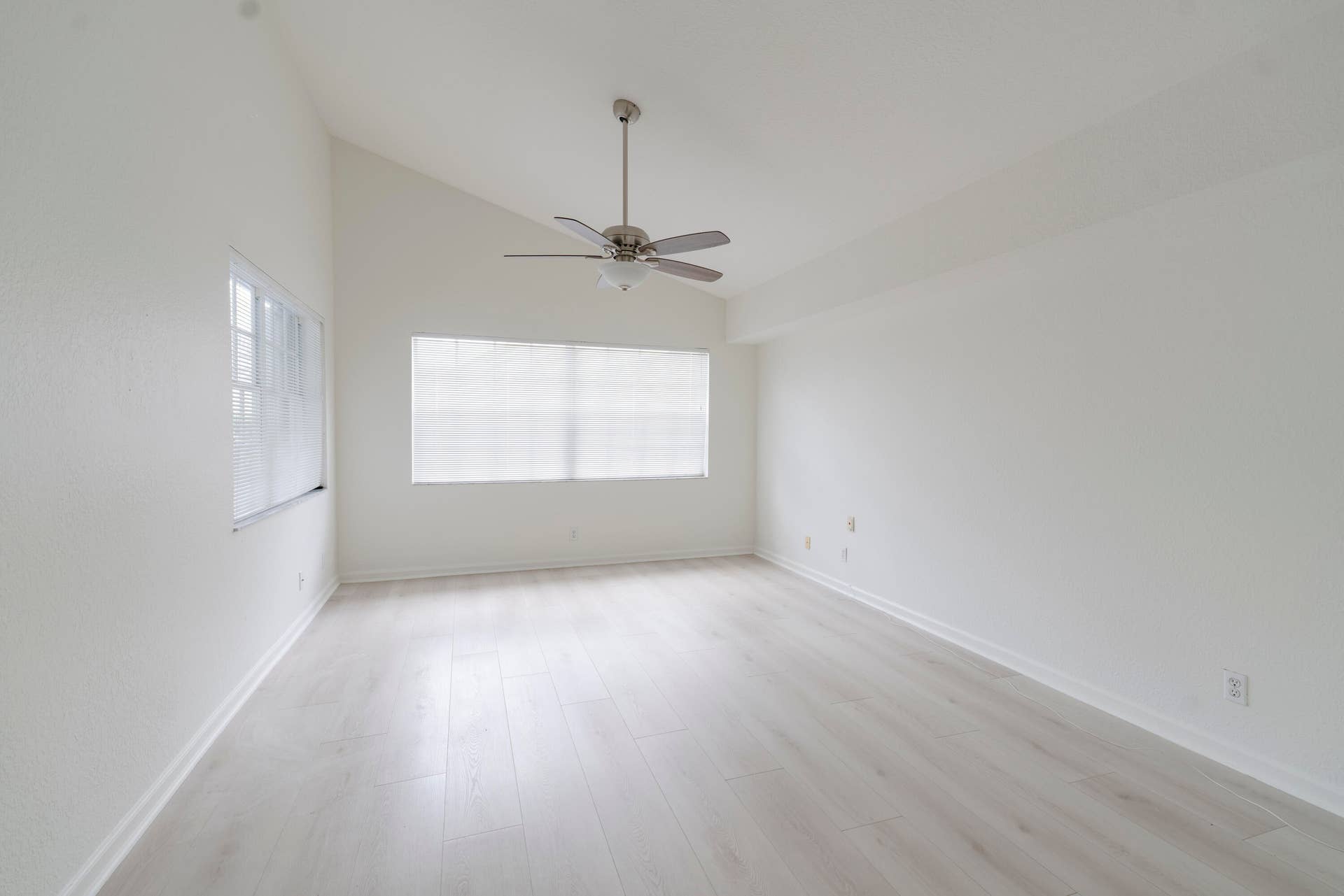6162 BAY ISLES Drive, Boynton Beach, FL 33437 Vaulted ceilings with a ceiling fan, light wood-finish flooring, and horizontal blinds on windows