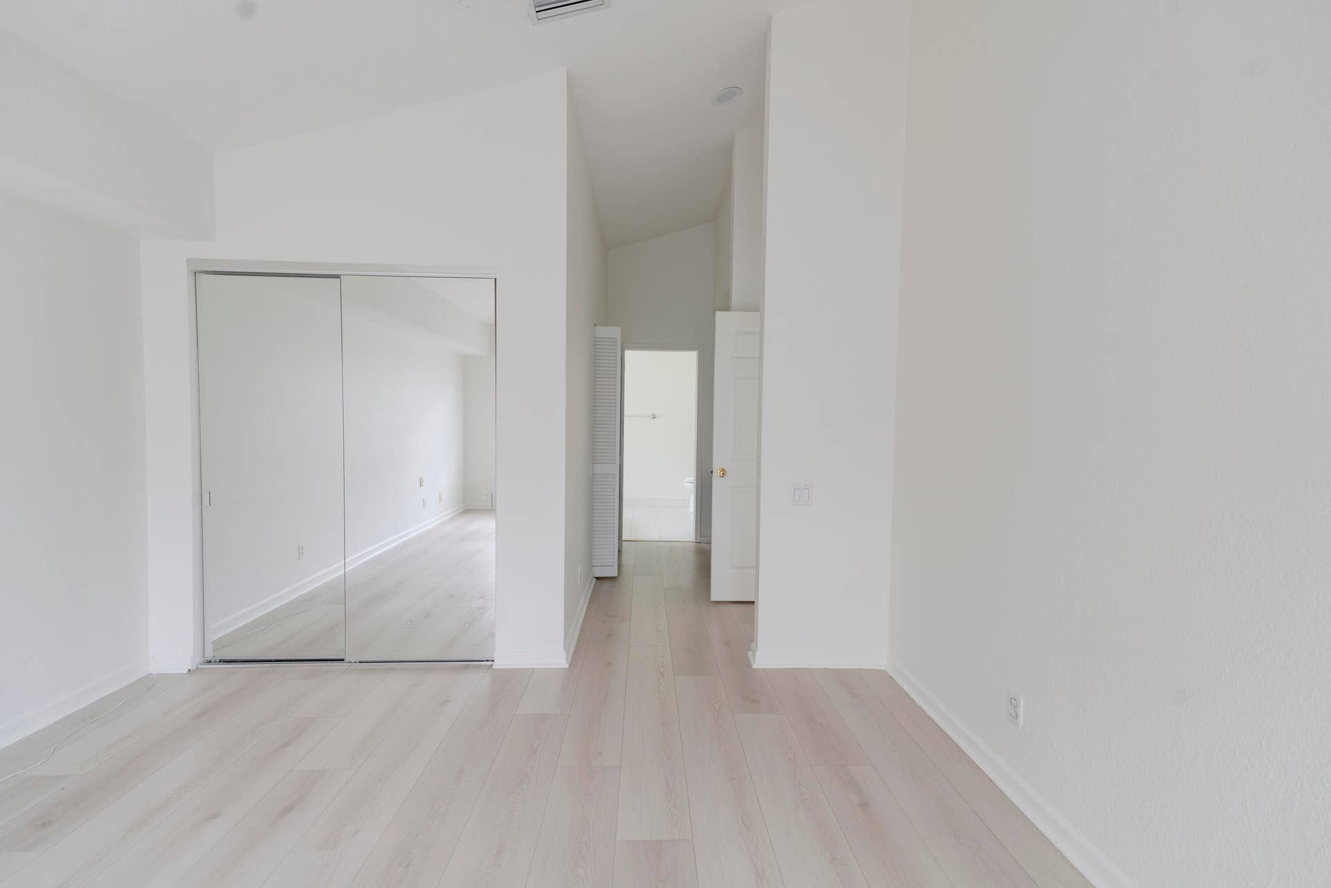 6162 BAY ISLES Drive, Boynton Beach, FL 33437 Vaulted ceiling, light wood-finish flooring, mirrored closet doors, and recessed lighting