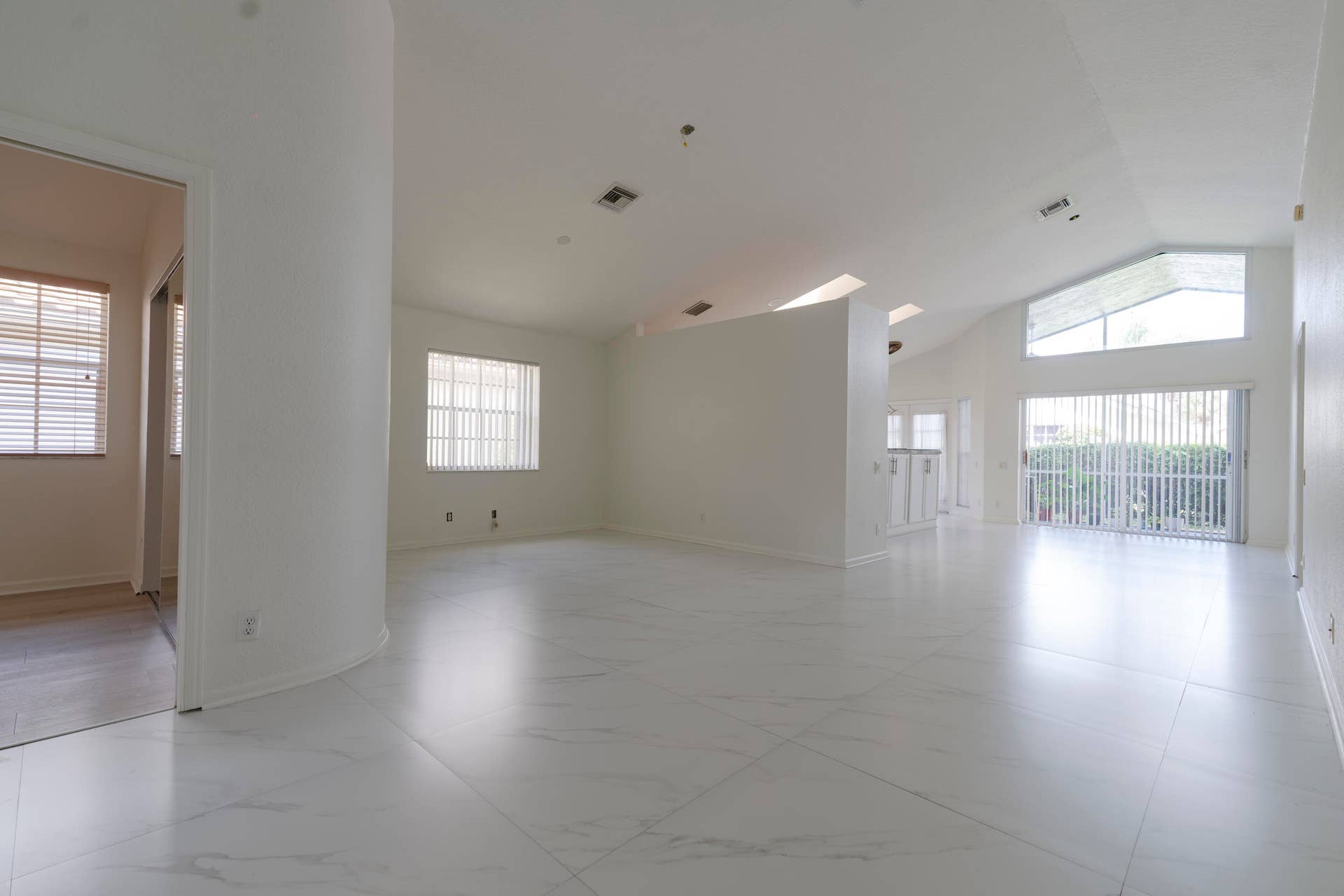 6162 BAY ISLES Drive, Boynton Beach, FL 33437 Expansive interior space featuring vaulted ceilings, light-toned flooring, and large sliding glass doors