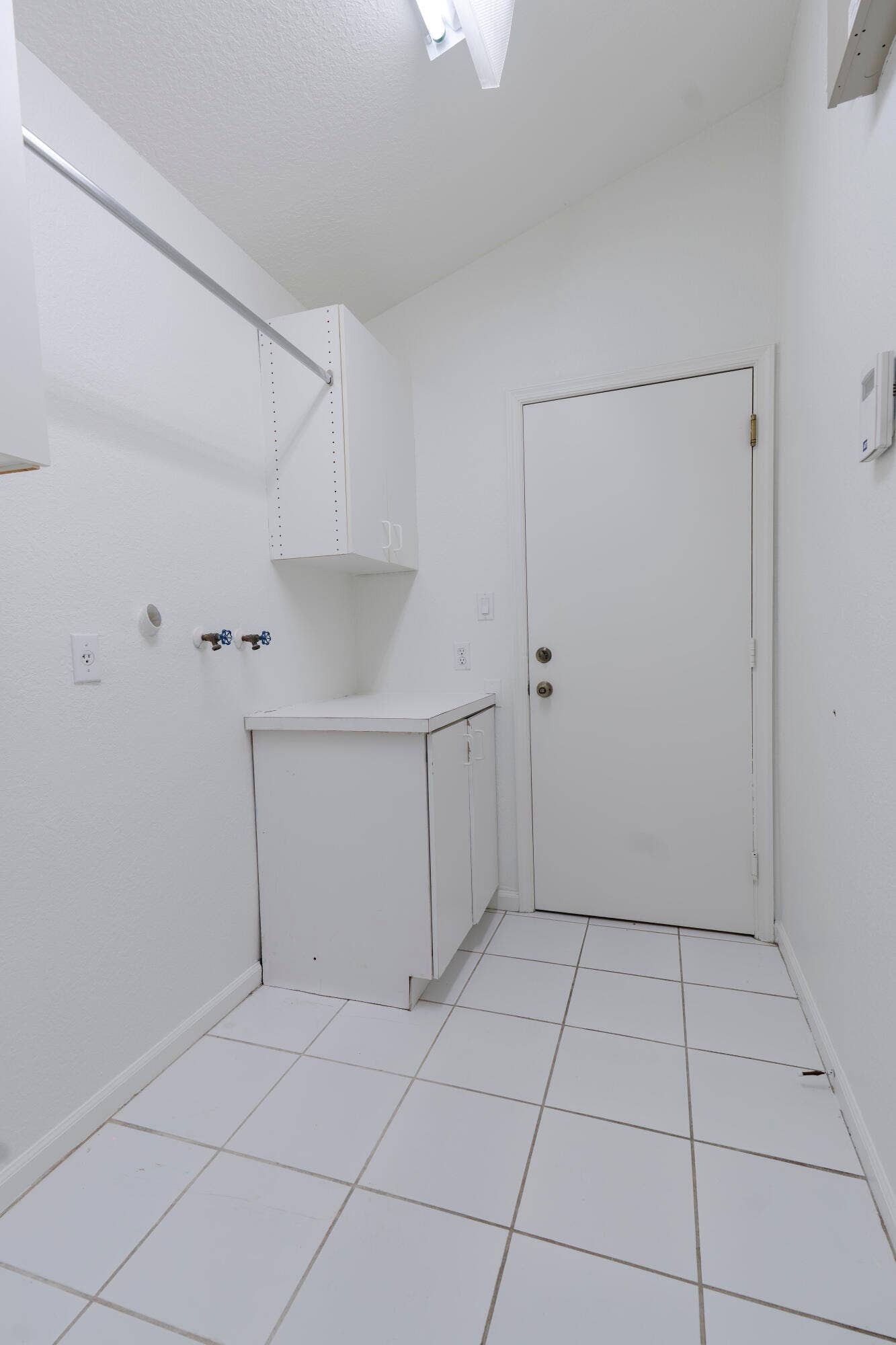 6162 BAY ISLES Drive, Boynton Beach, FL 33437 Ceramic tile flooring, built-in cabinetry, and integrated hanging rod