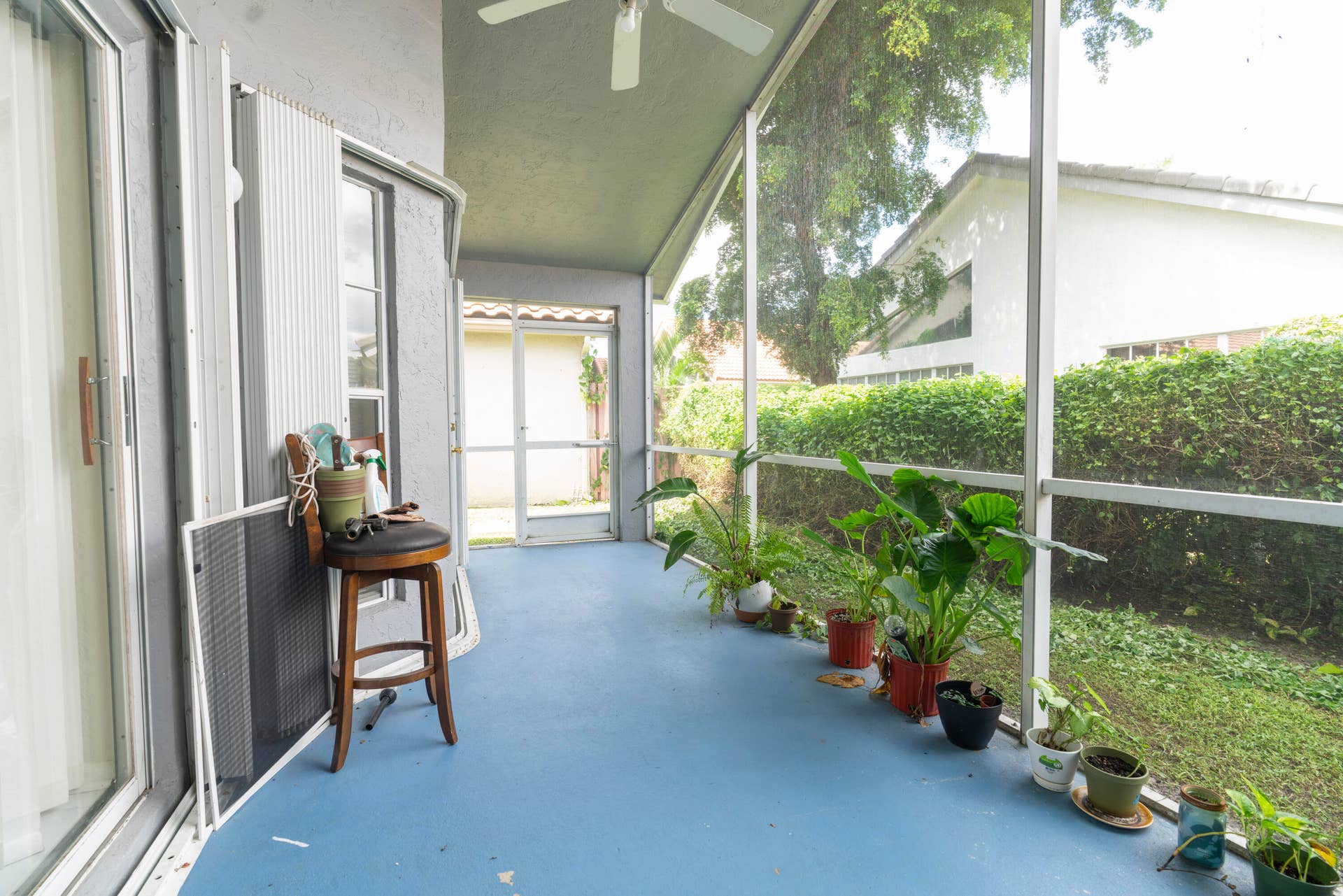 6162 BAY ISLES Drive, Boynton Beach, FL 33437 Screened patio with a painted concrete floor, ceiling fan, and exterior doors