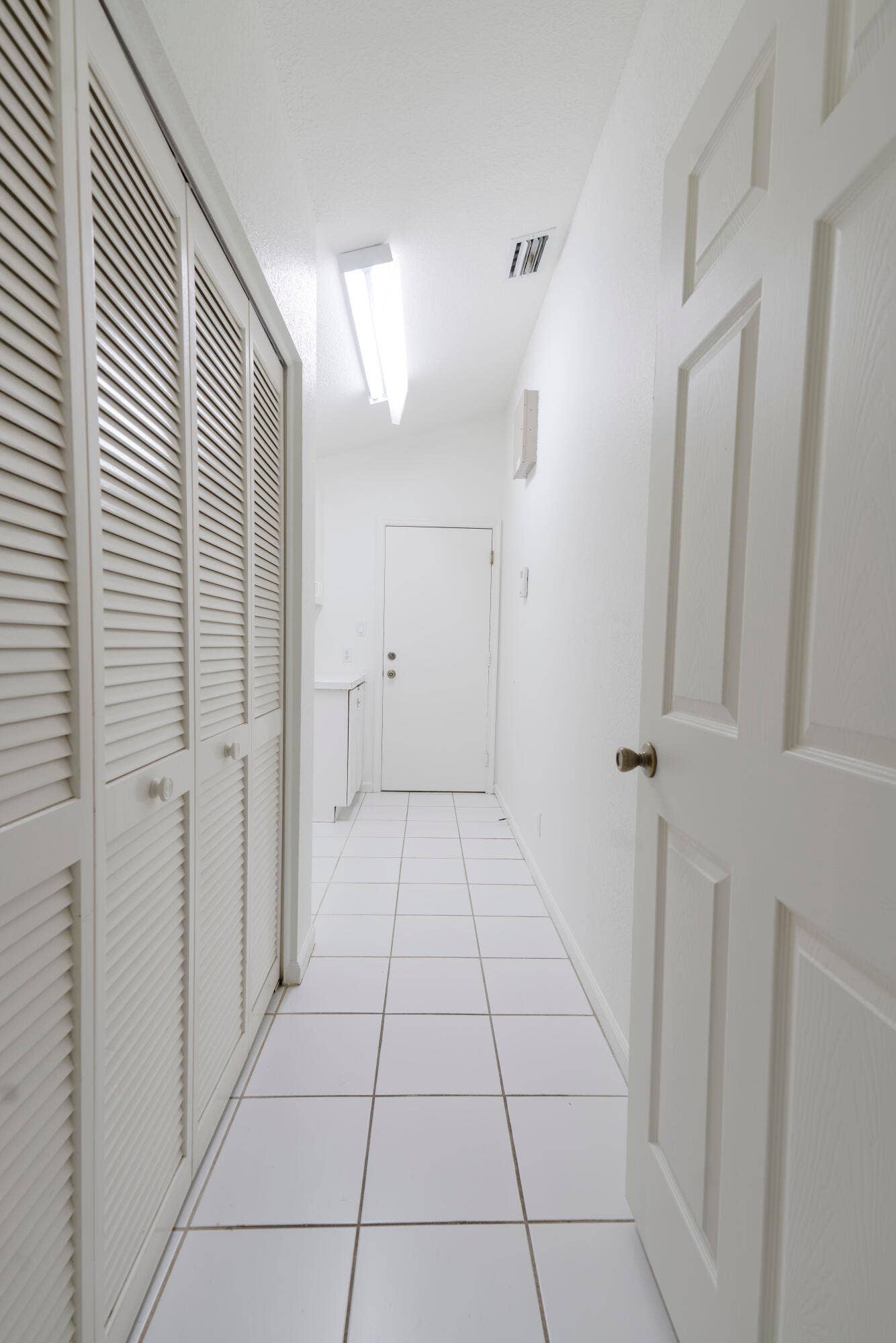 6162 BAY ISLES Drive, Boynton Beach, FL 33437 White tile flooring throughout, louvered bi-fold closet doors, contemporary overhead lighting, and a paneled interior door