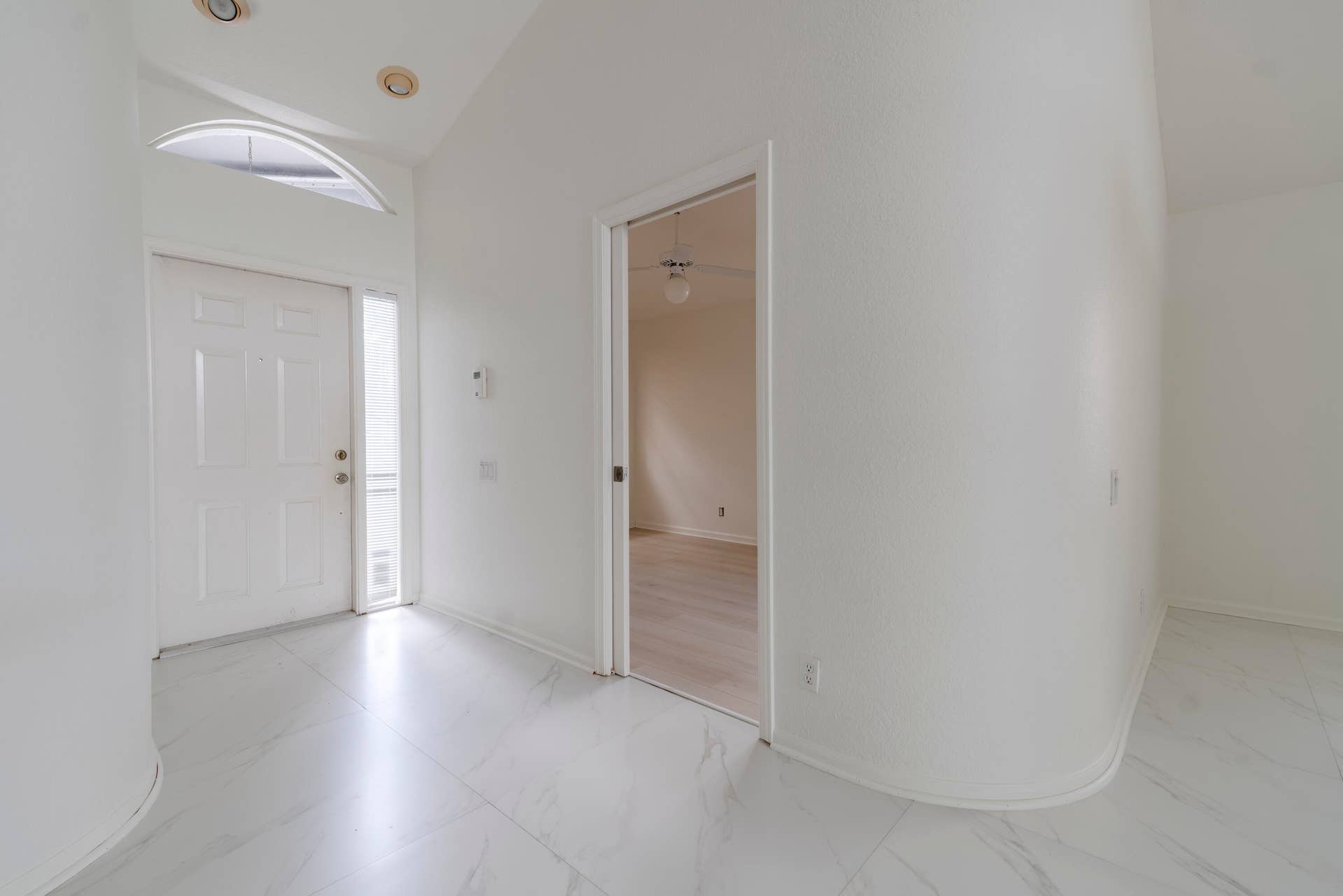 6162 BAY ISLES Drive, Boynton Beach, FL 33437 White paneled entry door with sidelight and arched transom window