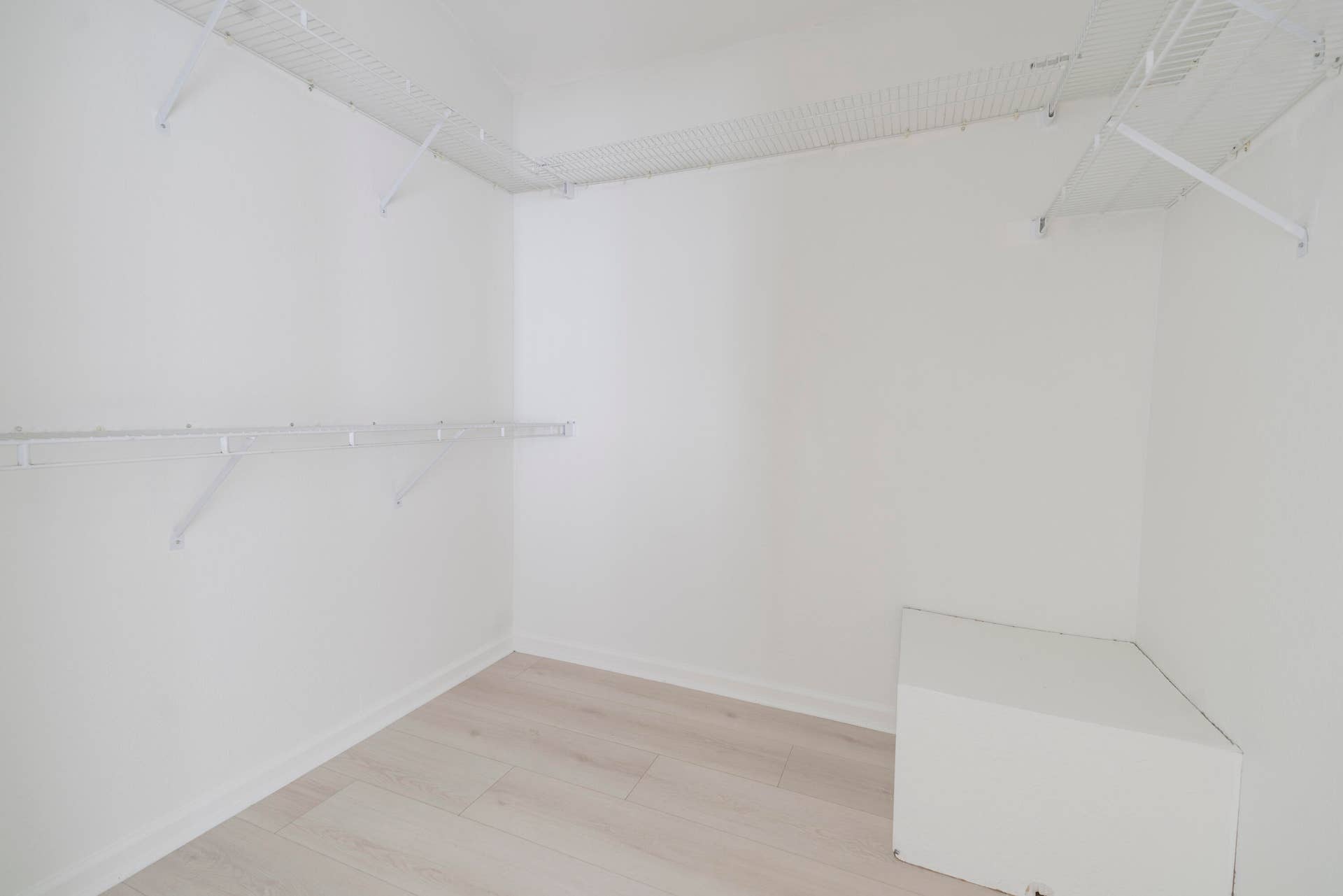 6162 BAY ISLES Drive, Boynton Beach, FL 33437 Walk-in closet featuring wire shelving, hanging rods, and wood-finish flooring