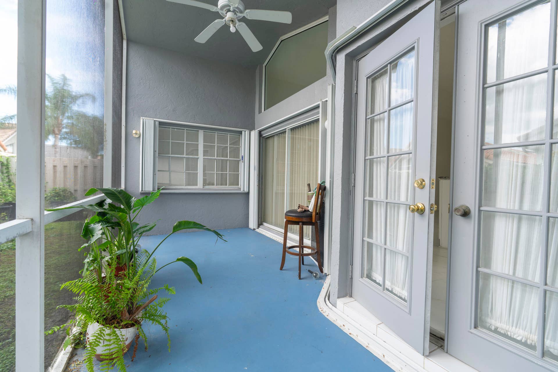 6162 BAY ISLES Drive, Boynton Beach, FL 33437 Screened patio featuring a ceiling fan, French doors, and sliding glass doors