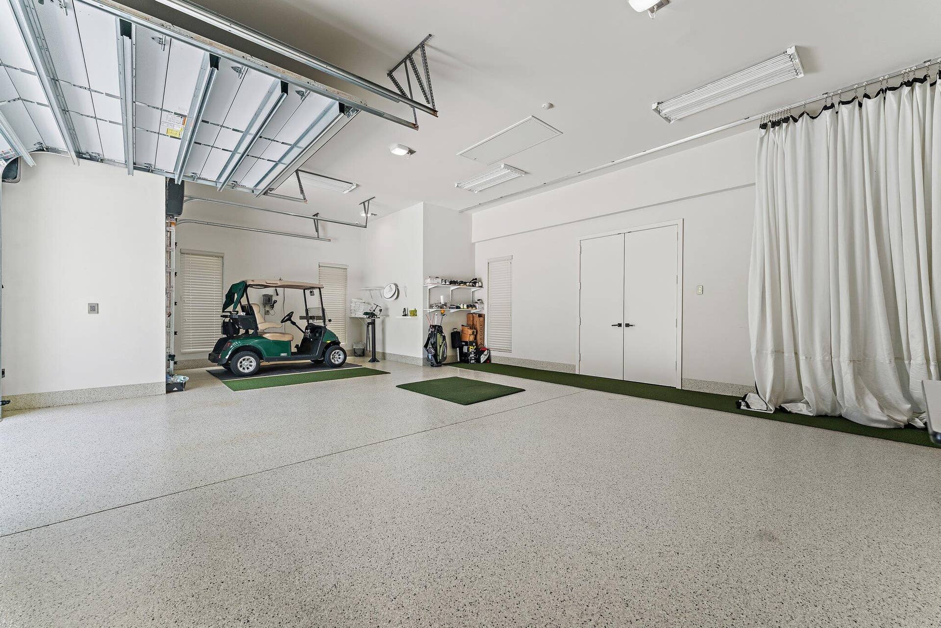 211 Bears Club Drive, Jupiter, FL 33477 Garage with Golf Hitting Net