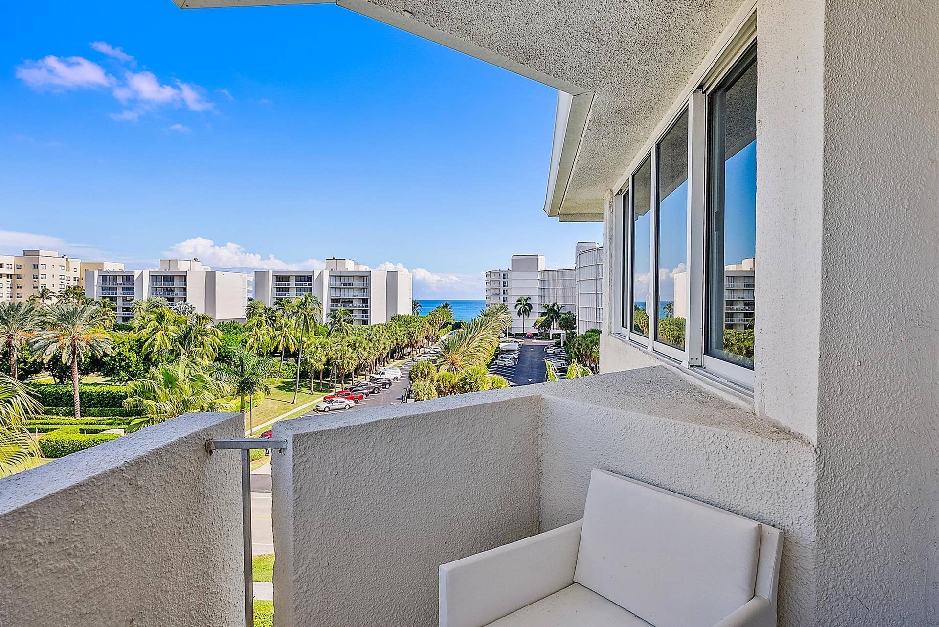2773 S Ocean Boulevard, #517, Palm Beach, Palm Beach, FL 33480 Private balcony with textured exterior walls, white-framed windows, and ocean scenery