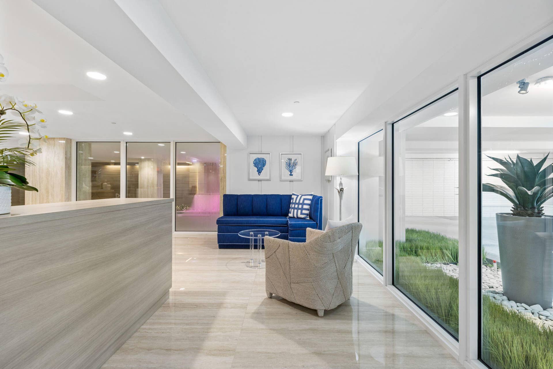2773 S Ocean Boulevard, #517, Palm Beach, Palm Beach, FL 33480 Light-toned tile flooring, recessed ceiling lighting, a reception desk with wood-finish paneling, and an interior planter with decorative white stones