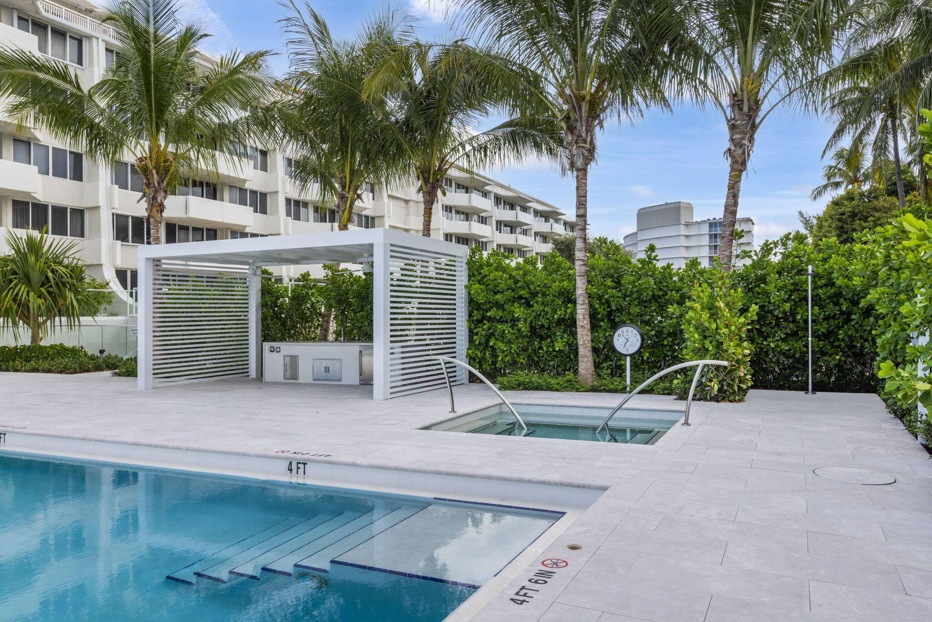 2773 S Ocean Boulevard, #517, Palm Beach, Palm Beach, FL 33480 Swimming pool with integrated steps, adjacent spa, and surrounding light-toned paved deck