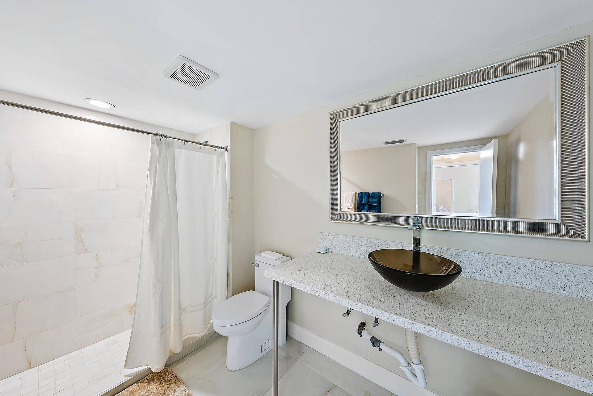 2773 S Ocean Boulevard, #517, Palm Beach, Palm Beach, FL 33480 White tile flooring, full wall mirror, glass vessel sink, white countertop, and tiled shower surround