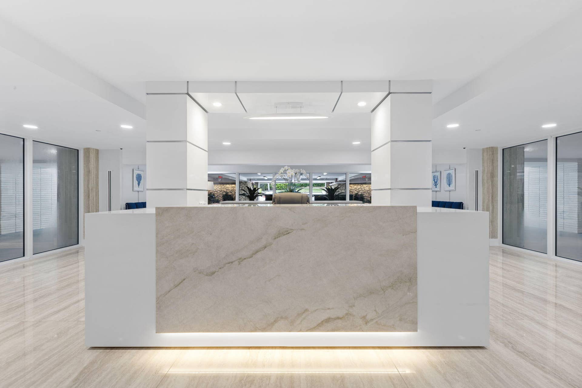 2773 S Ocean Boulevard, #517, Palm Beach, Palm Beach, FL 33480 Lobby area featuring a stone-finish reception desk with integrated lighting, polished tile flooring, and recessed ceiling lighting