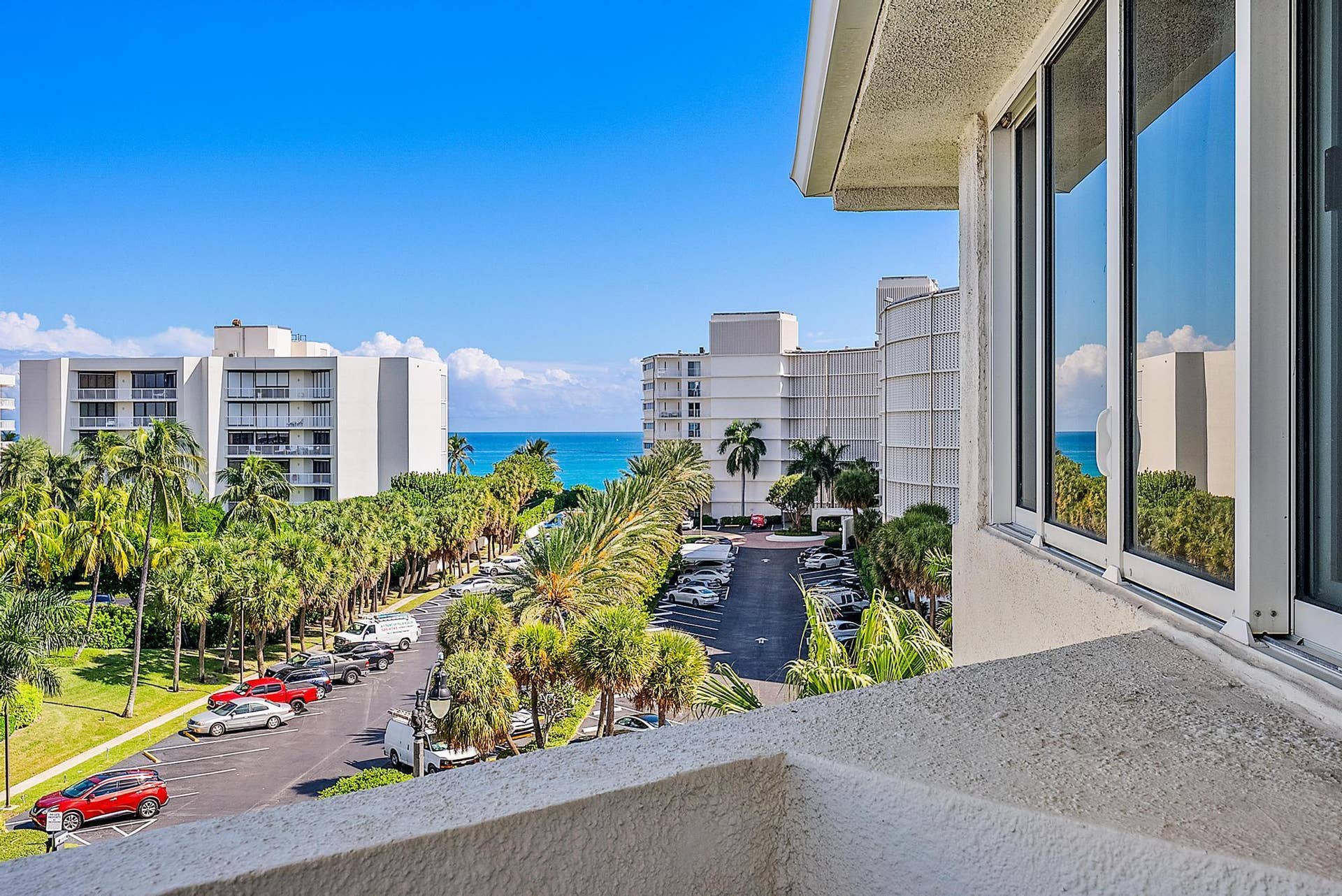 2773 S Ocean Boulevard, #517, Palm Beach, Palm Beach, FL 33480 Expansive water body, lush palm trees, and clear blue sky visible from the property