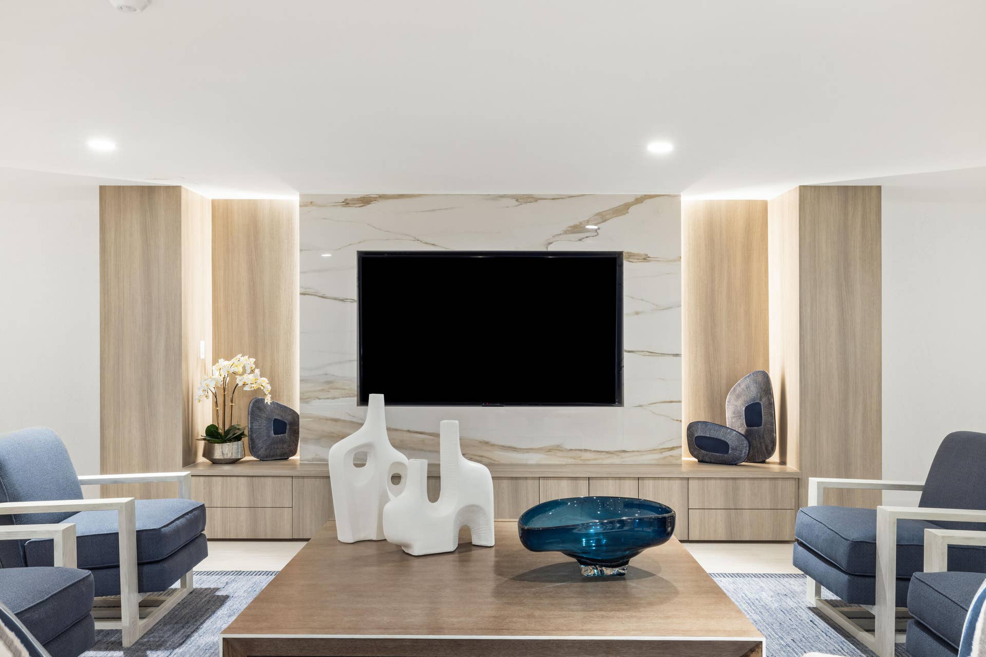 2773 S Ocean Boulevard, #517, Palm Beach, Palm Beach, FL 33480 Built-in media console with wood-finish cabinetry, integrated shelving, and a stone-look accent wall
