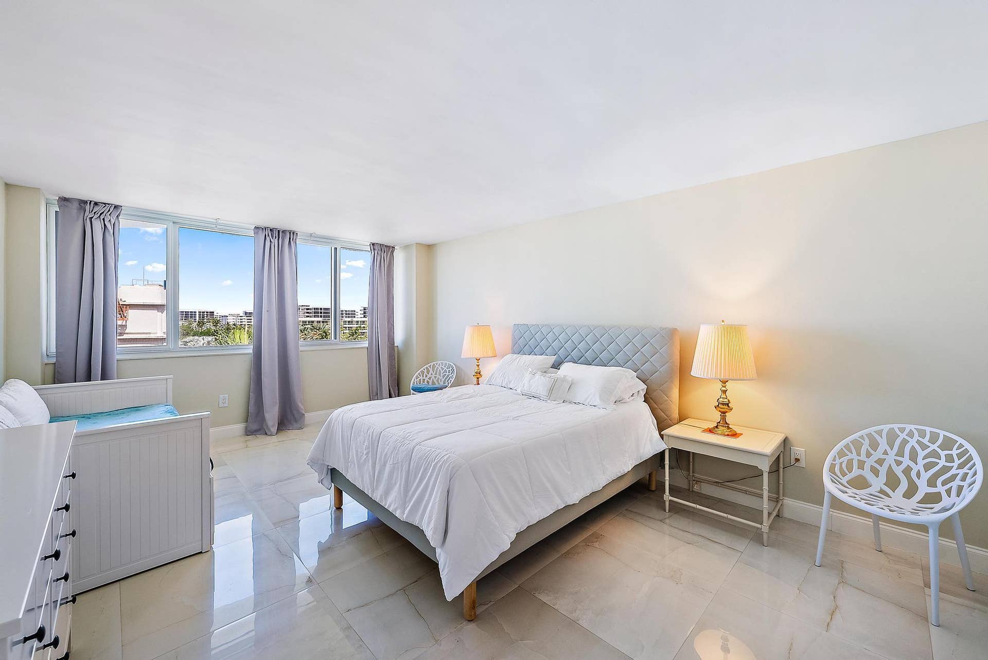 2773 S Ocean Boulevard, #517, Palm Beach, Palm Beach, FL 33480 Expansive windows with city backdrop, light-toned walls, and large format tile flooring