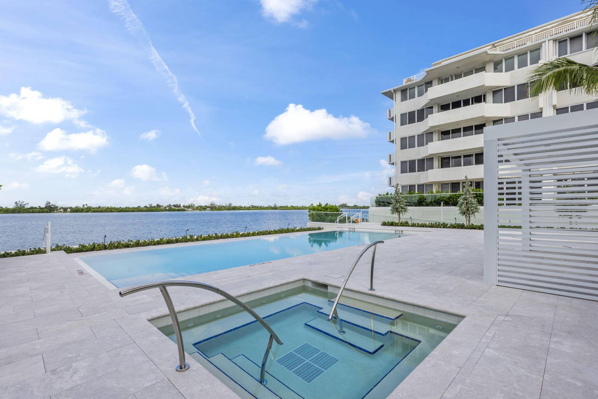 2773 S Ocean Boulevard, #517, Palm Beach, Palm Beach, FL 33480 Waterfront property featuring a rectangular pool, integrated spa, and expansive patio with light-toned pavers