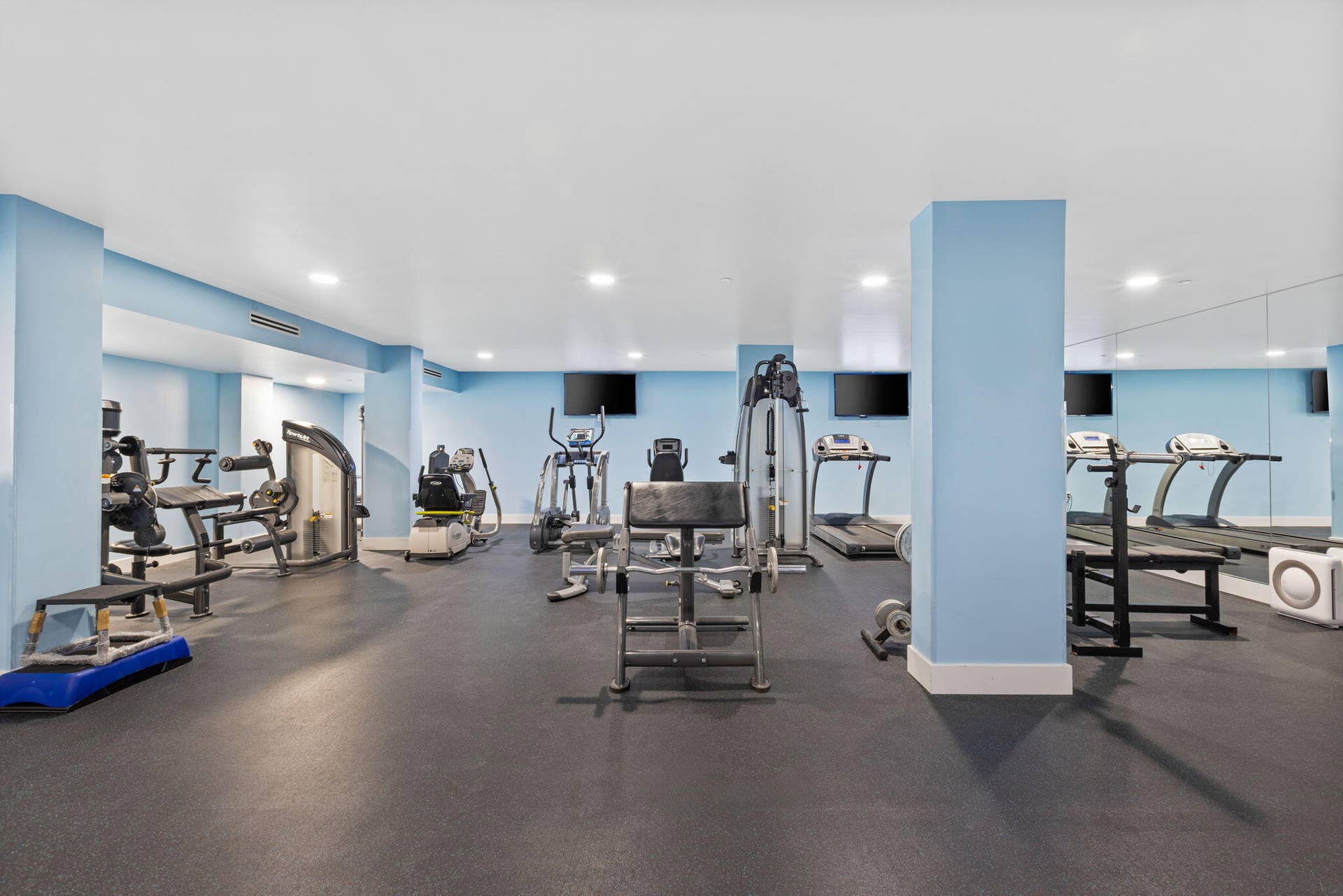 2773 S Ocean Boulevard, #517, Palm Beach, Palm Beach, FL 33480 Fitness center featuring multiple exercise machines, mirrored wall, recessed lighting, and rubber flooring