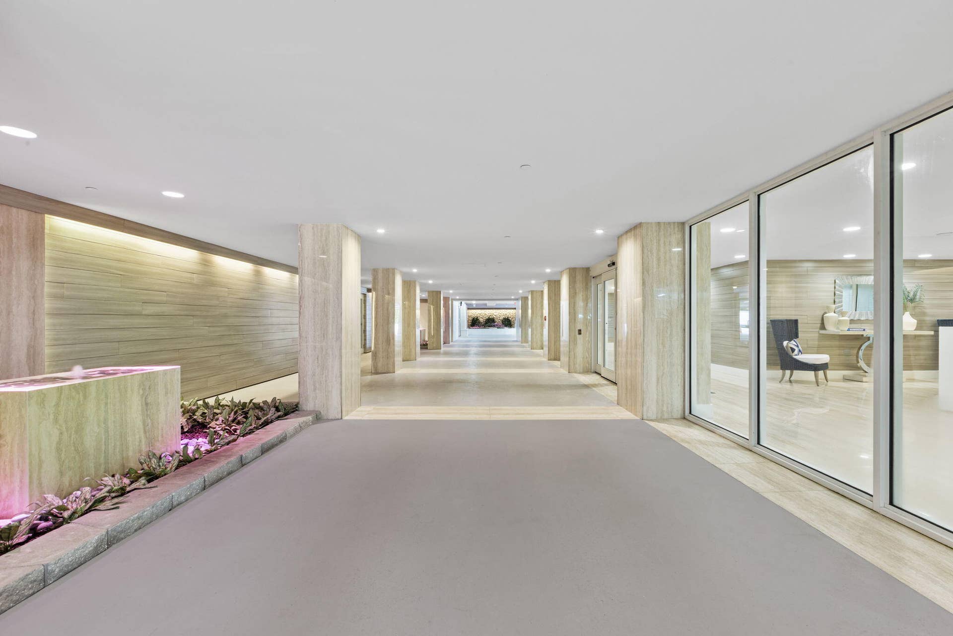 2773 S Ocean Boulevard, #517, Palm Beach, Palm Beach, FL 33480 Recessed lighting illuminates a long hallway with full-height glass panels