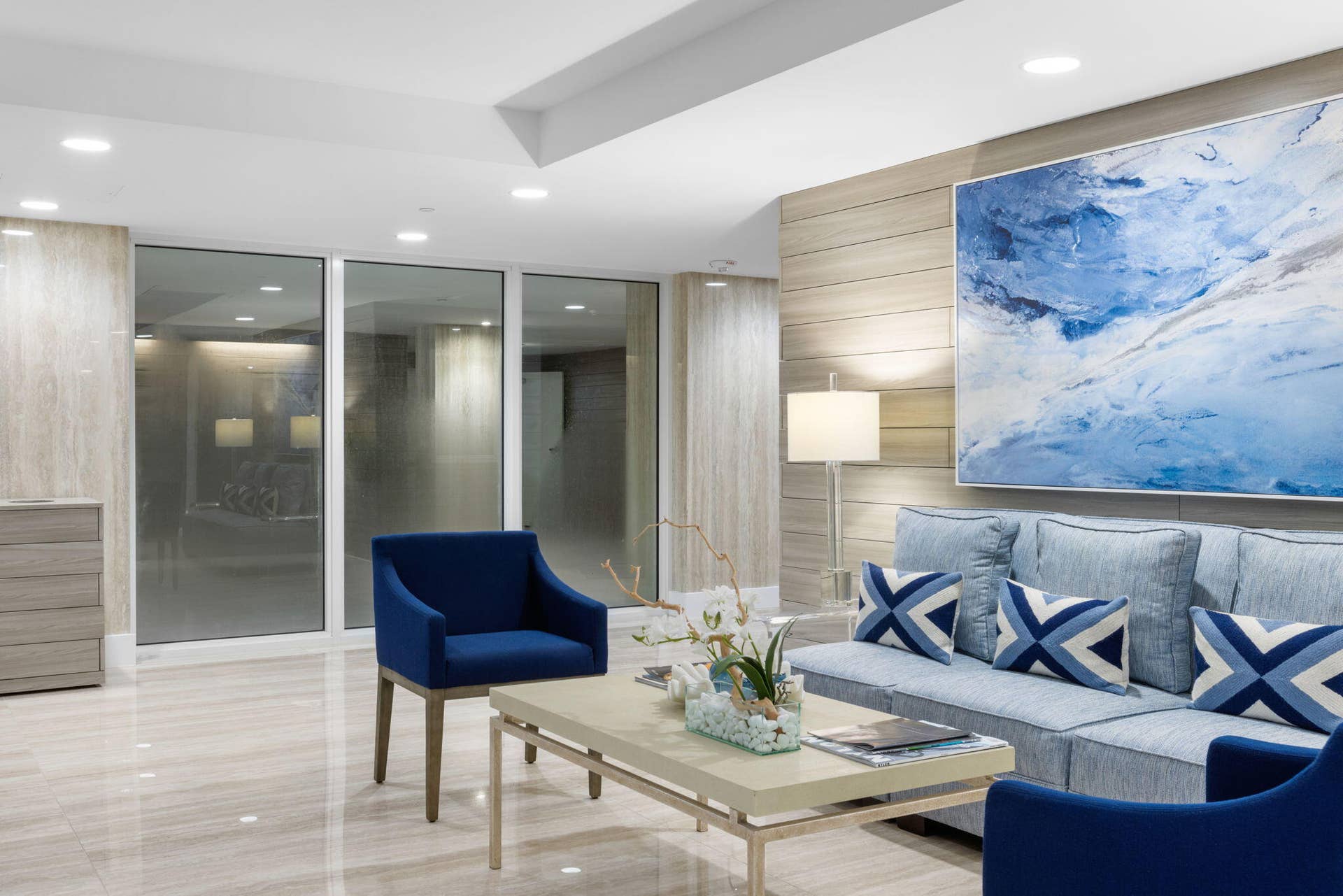 2773 S Ocean Boulevard, #517, Palm Beach, Palm Beach, FL 33480 Recessed lighting, large format tile flooring, a horizontal wood-finish accent wall, and expansive glass panels