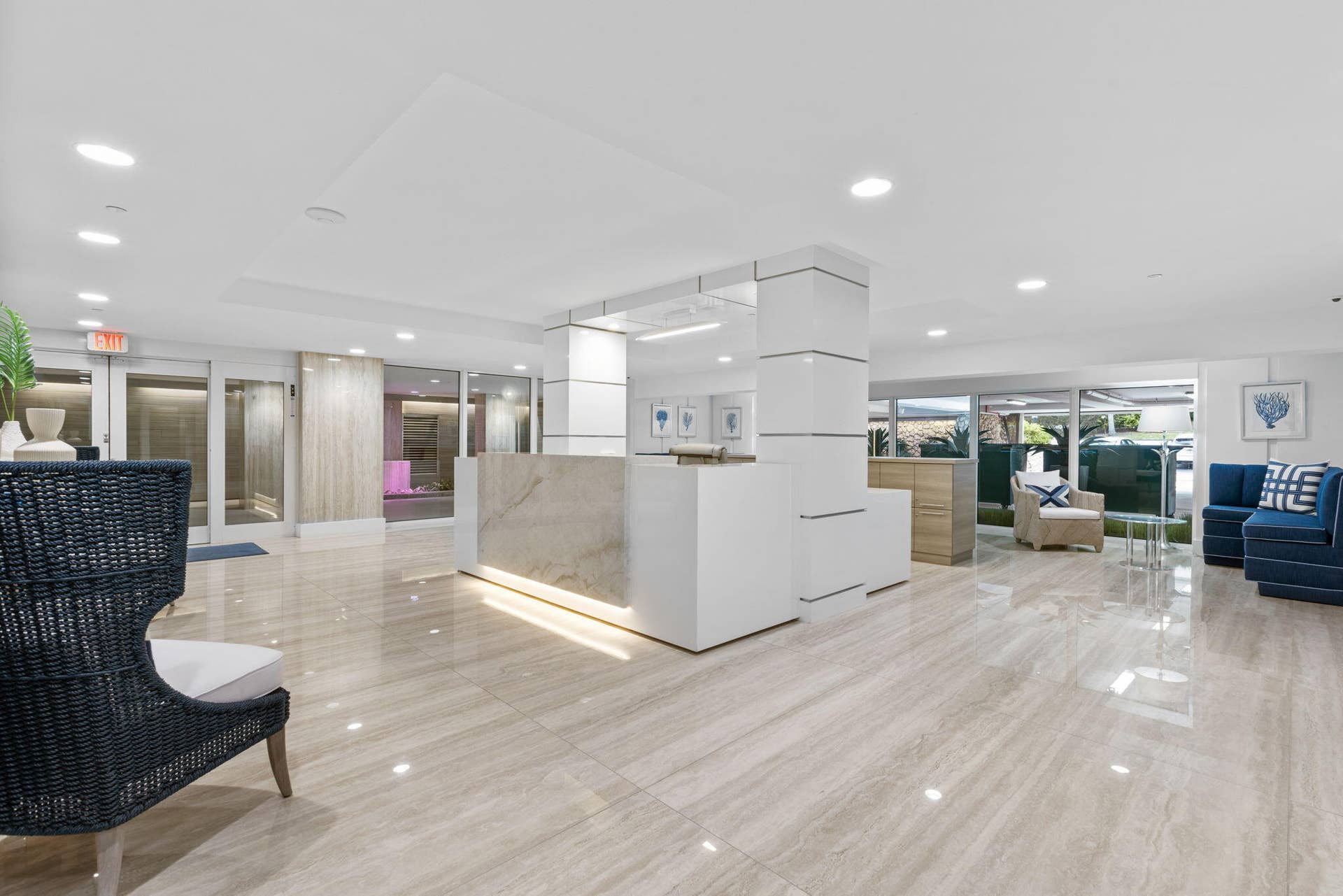 2773 S Ocean Boulevard, #517, Palm Beach, Palm Beach, FL 33480 Lobby featuring polished stone-finish flooring, a reception desk with stone detailing, recessed lighting, and expansive window panels