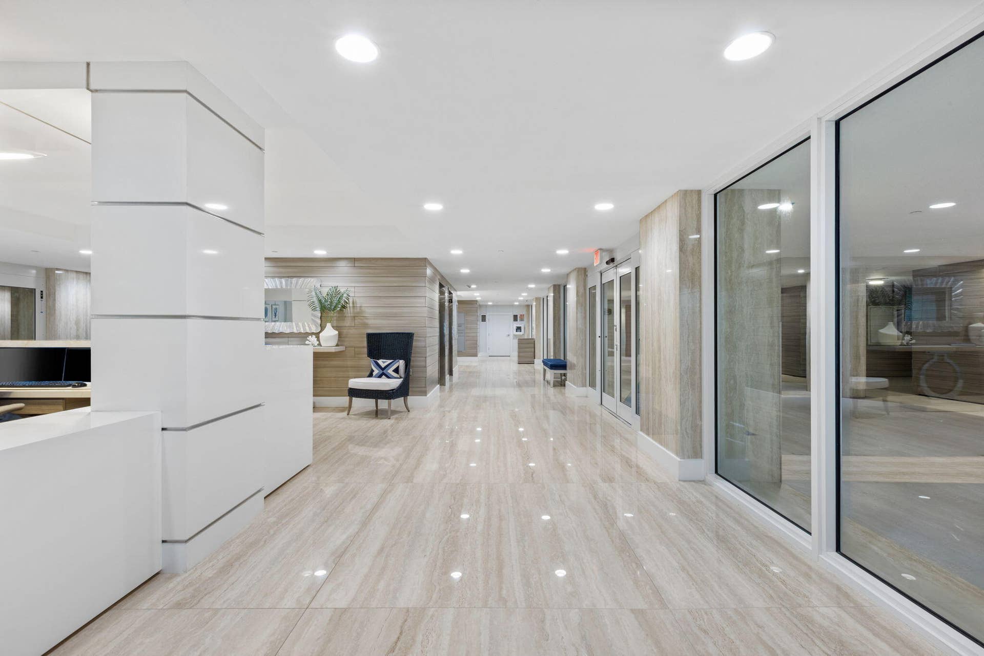 2773 S Ocean Boulevard, #517, Palm Beach, Palm Beach, FL 33480 Reflective tiled flooring, recessed lighting, wood-finish wall panels, and full-height glass partitions
