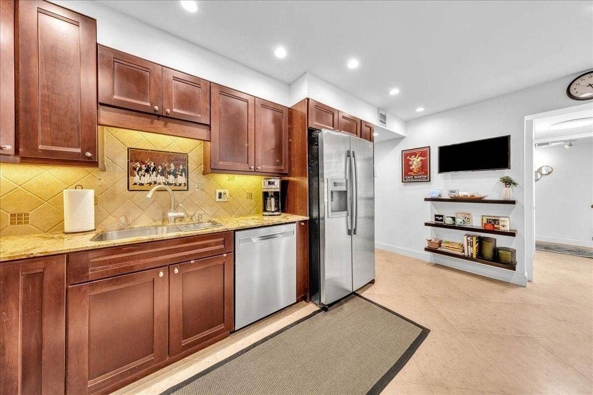 3505 Oaks Way, #109, Pompano Beach, FL 33069 Kitchen featuring cherry wood cabinetry, stainless steel appliances, granite-countertops, and recessed lighting