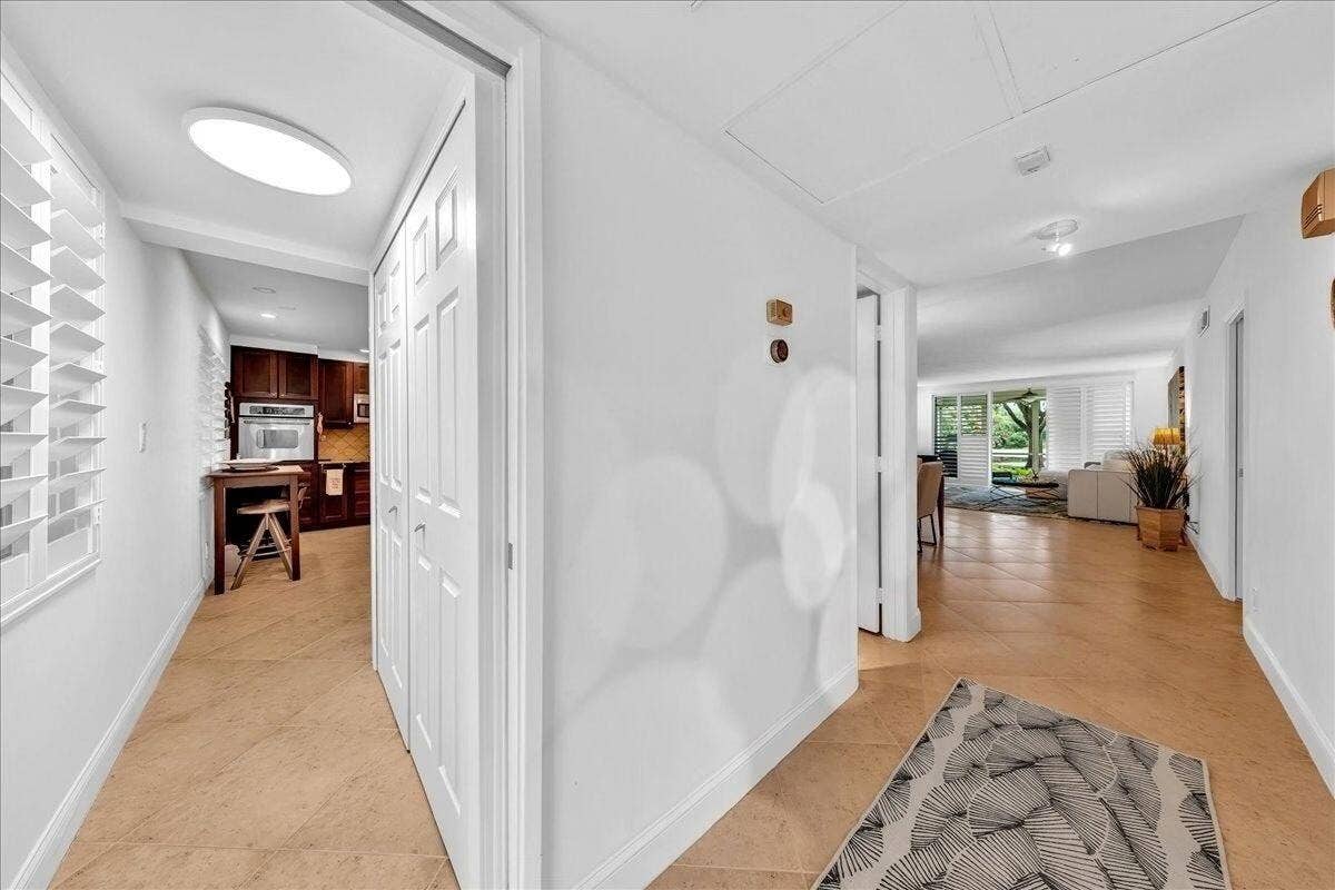 3505 Oaks Way, #109, Pompano Beach, FL 33069 View of laundry closet, foyer, and liv
