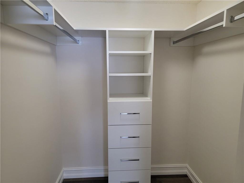 1001 SE 6TH Avenue, #127, Deerfield Beach, Deerfield Beach, FL 33441 Built-in closet system featuring multiple shelves, hanging rods, and four drawers with polished chrome hardware