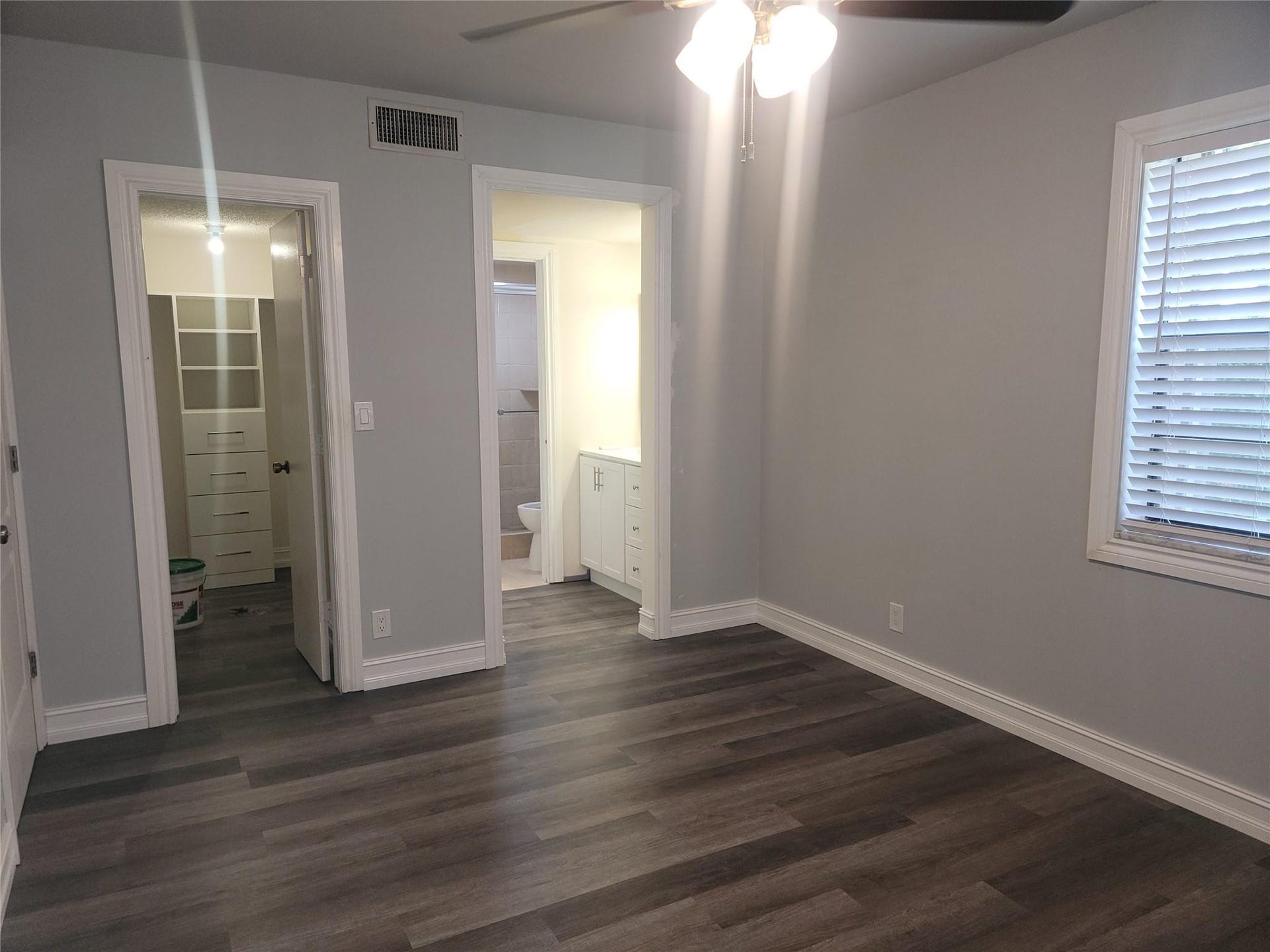 1001 SE 6TH Avenue, #127, Deerfield Beach, Deerfield Beach, FL 33441 Wood-finish flooring, ceiling fan with integrated lighting, window with blinds, base molding, and built-in closet organization system
