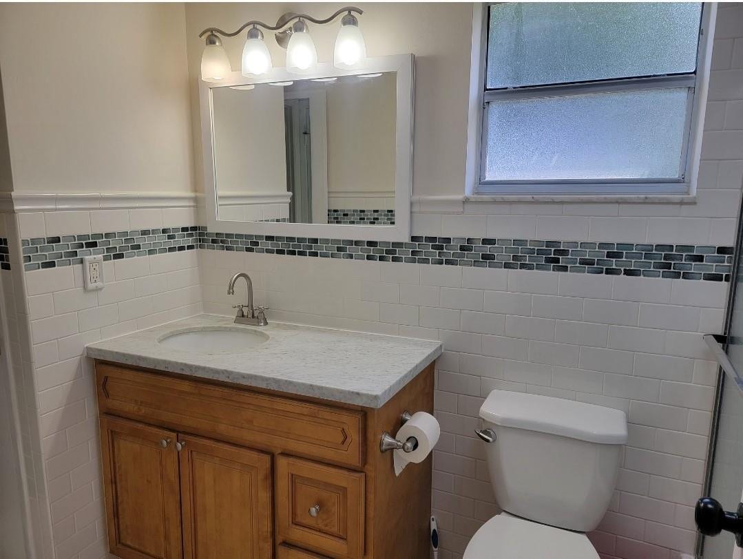 1001 SE 6TH Avenue, #127, Deerfield Beach, Deerfield Beach, FL 33441 Wood-finish vanity with a light-toned countertop, undermount sink, and polished chrome faucet