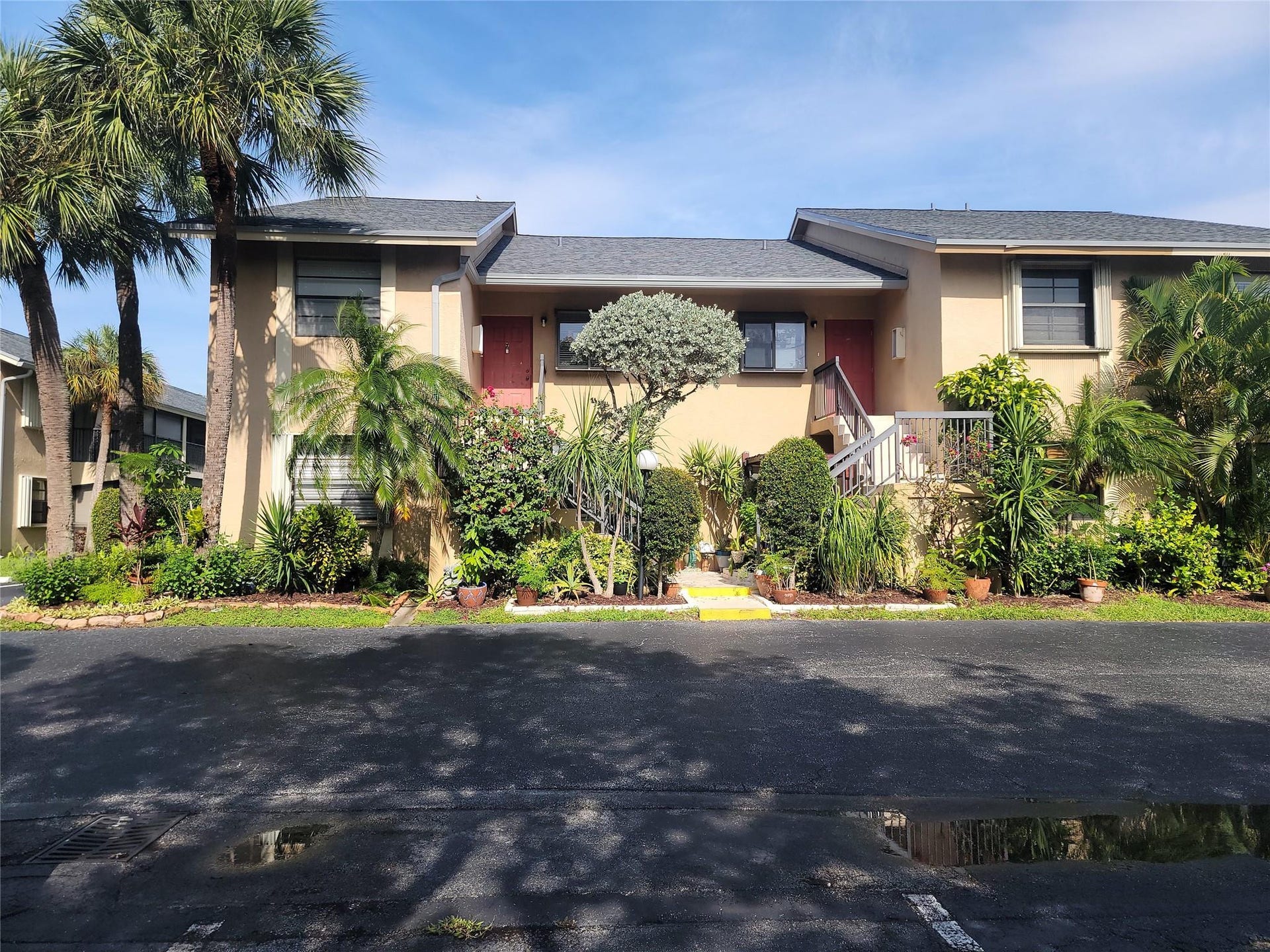 1001 SE 6TH Avenue, #127, Deerfield Beach, Deerfield Beach, FL 33441 Two-story stucco exterior with dual entryways, each featuring a staircase and front door