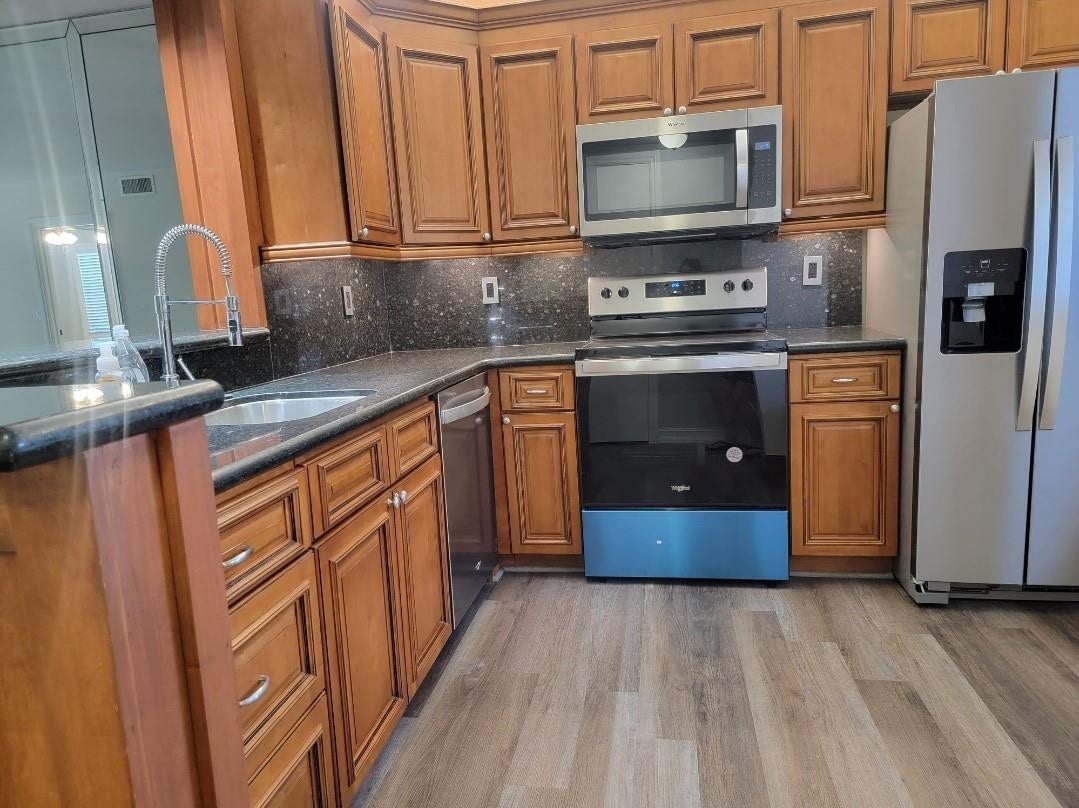 1001 SE 6TH Avenue, #127, Deerfield Beach, Deerfield Beach, FL 33441 Wood-finish flooring paired with rich wood cabinetry